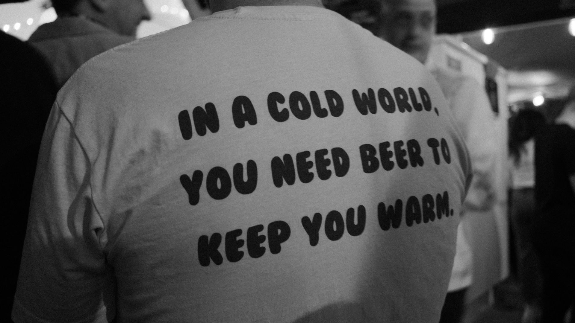 Man wears shirt with beer quote: keep you warm text.