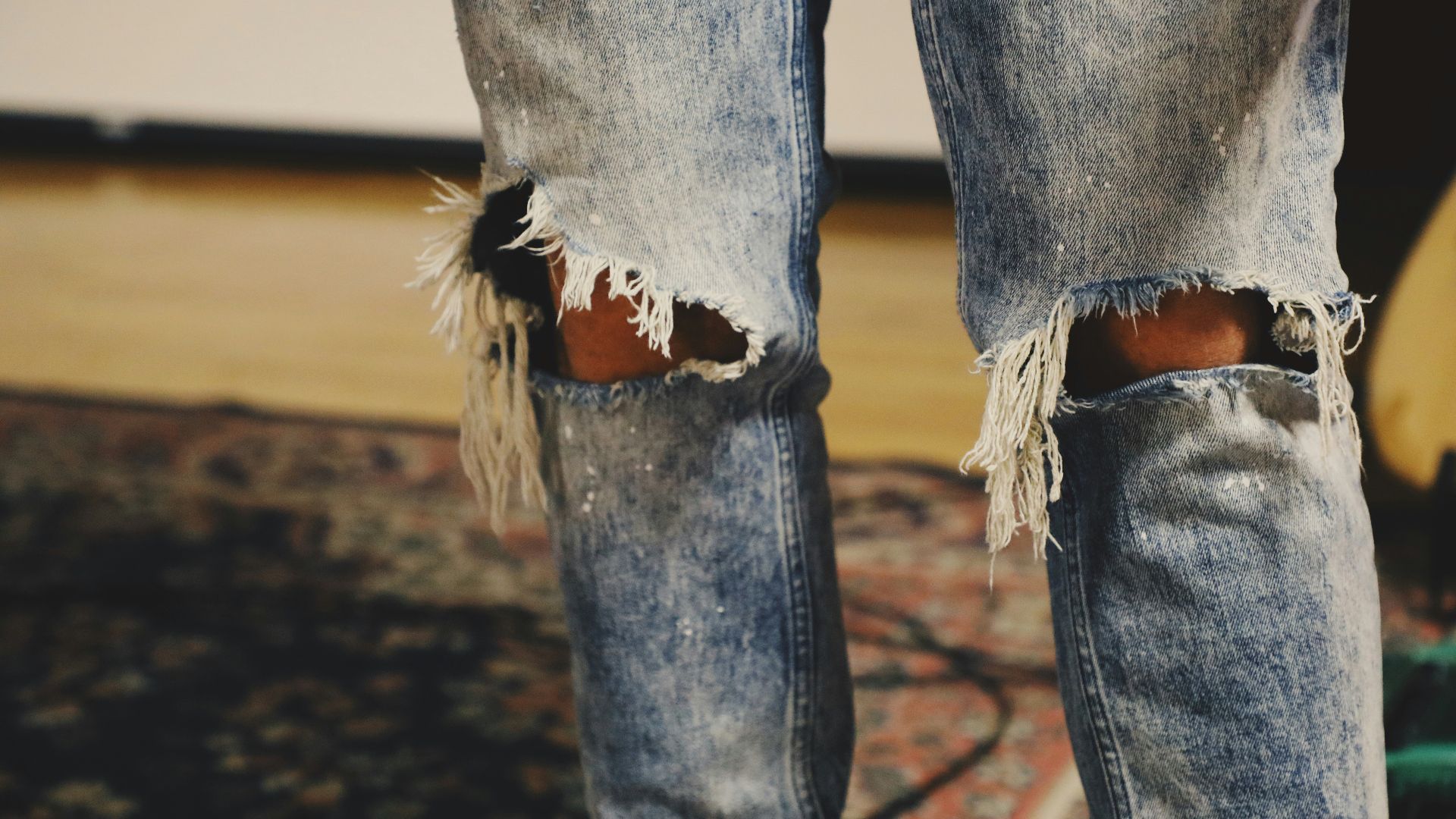 person standing on floral area rug