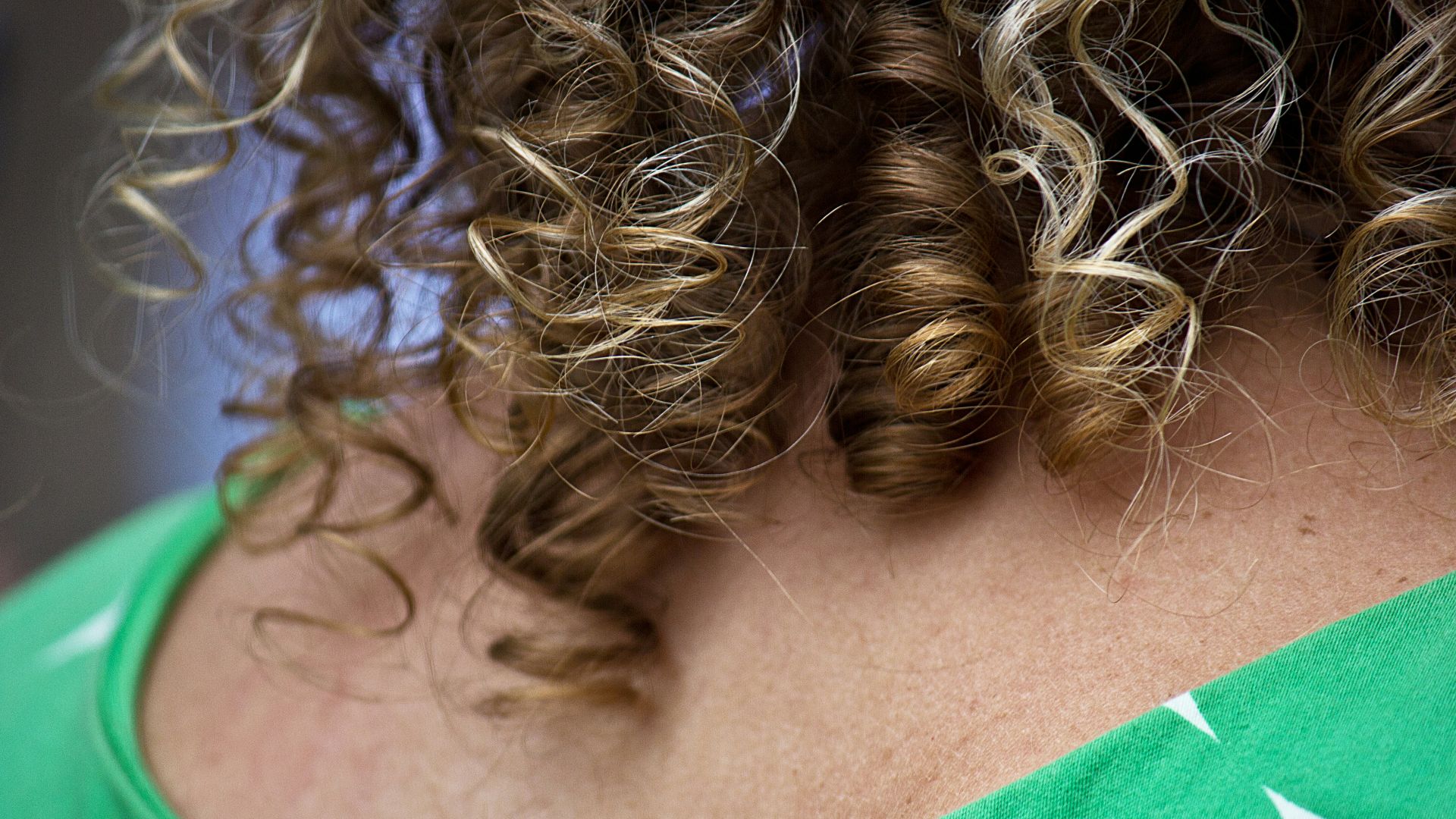 A close up of a woman with curly hair