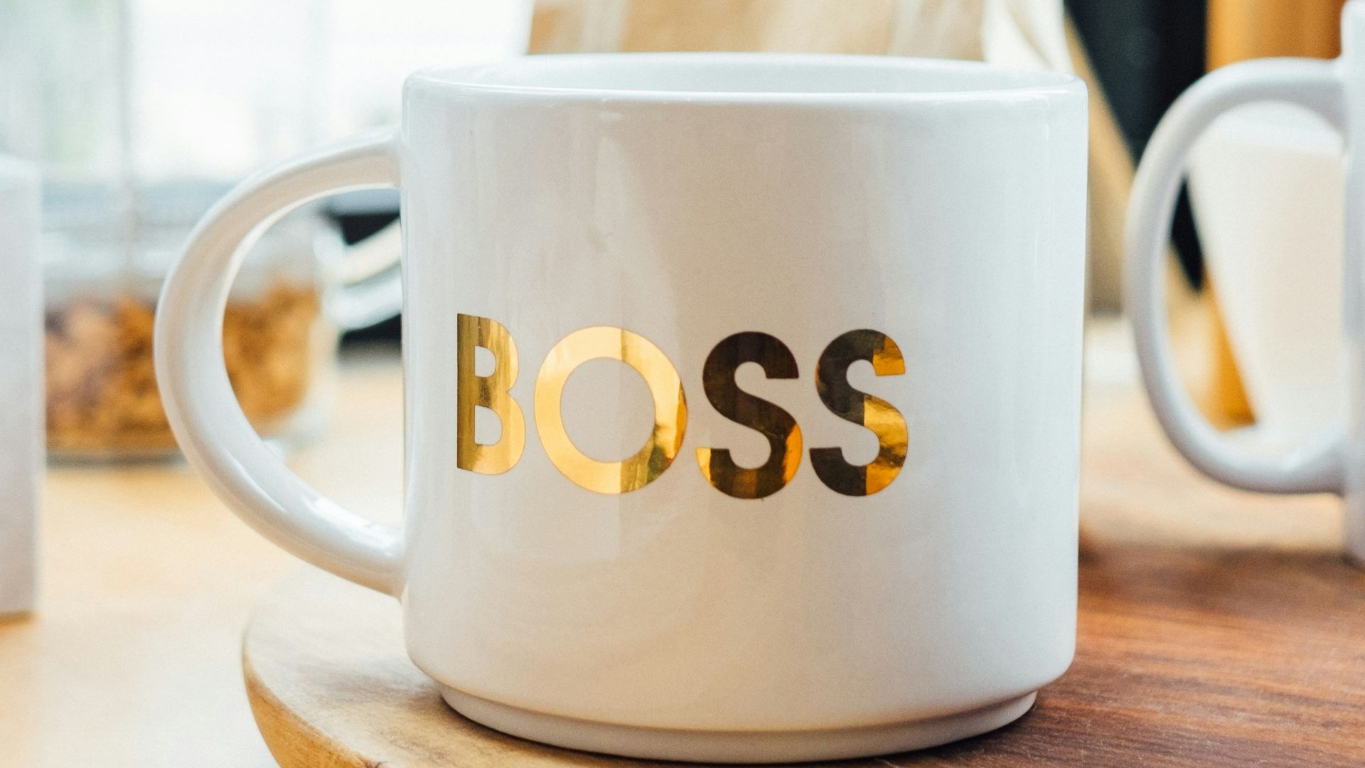white Boss-printed ceramic mug on brown surface