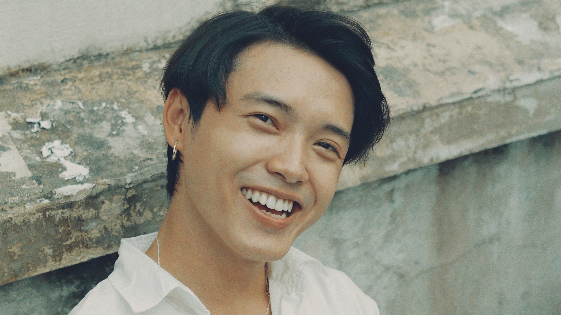 woman in white button up shirt smiling