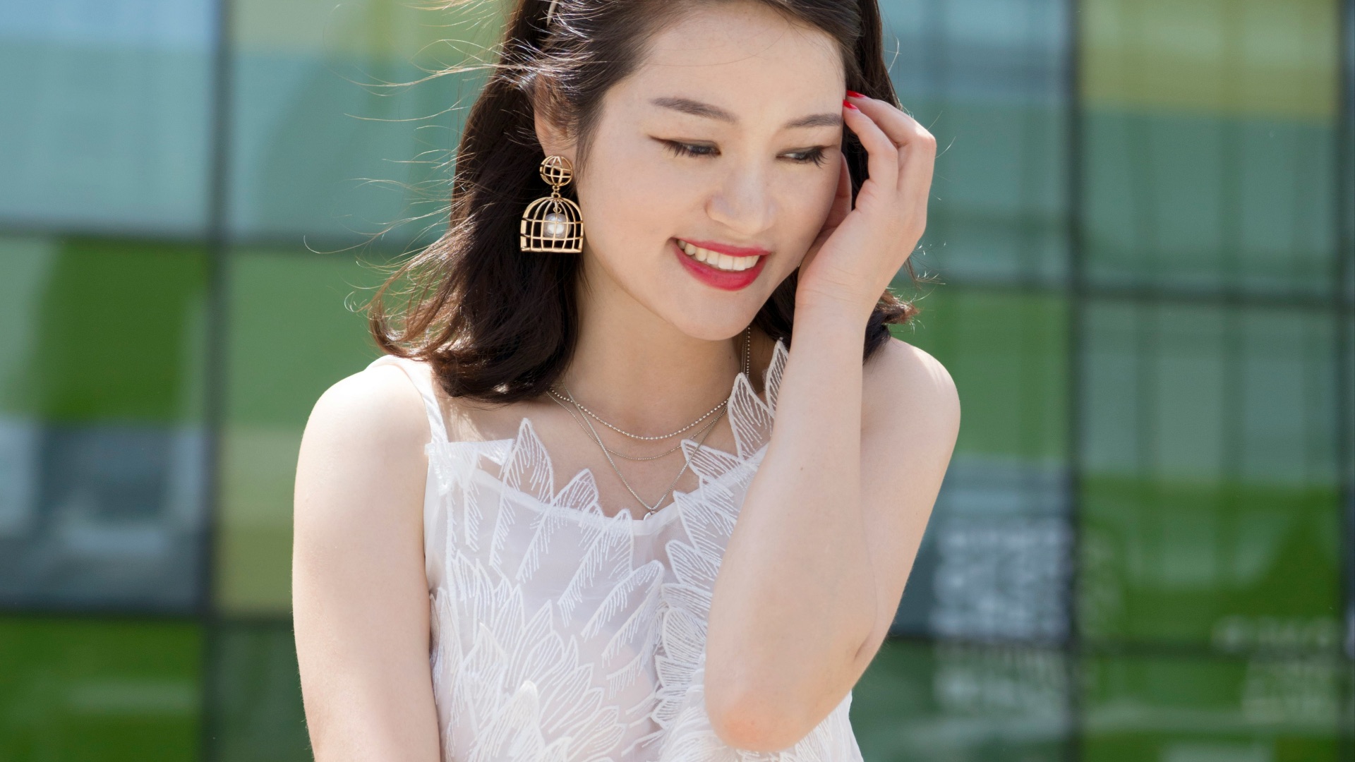woman holding her head while sitting on table