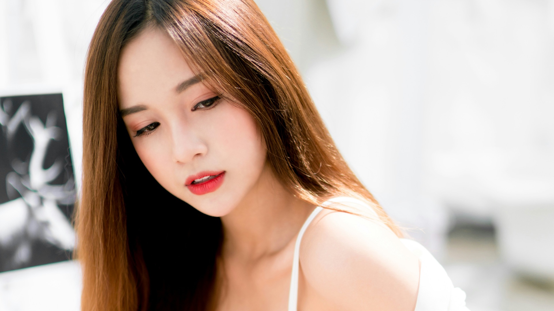 woman sitting on white metal stair railing during daytime