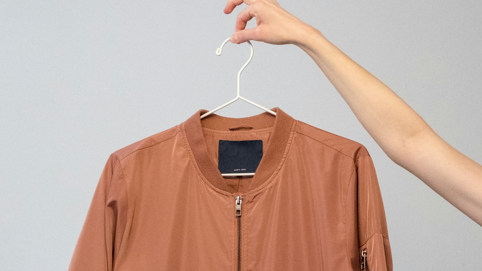 brown long sleeve shirt on white clothes hanger