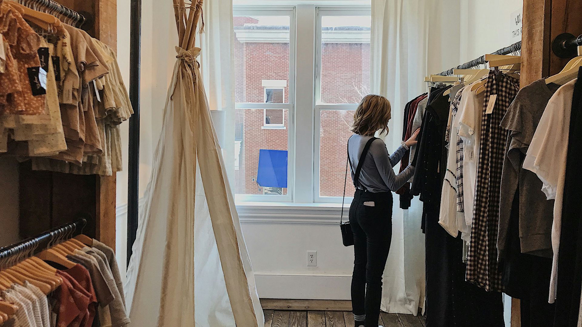 woman standing selecting clothes