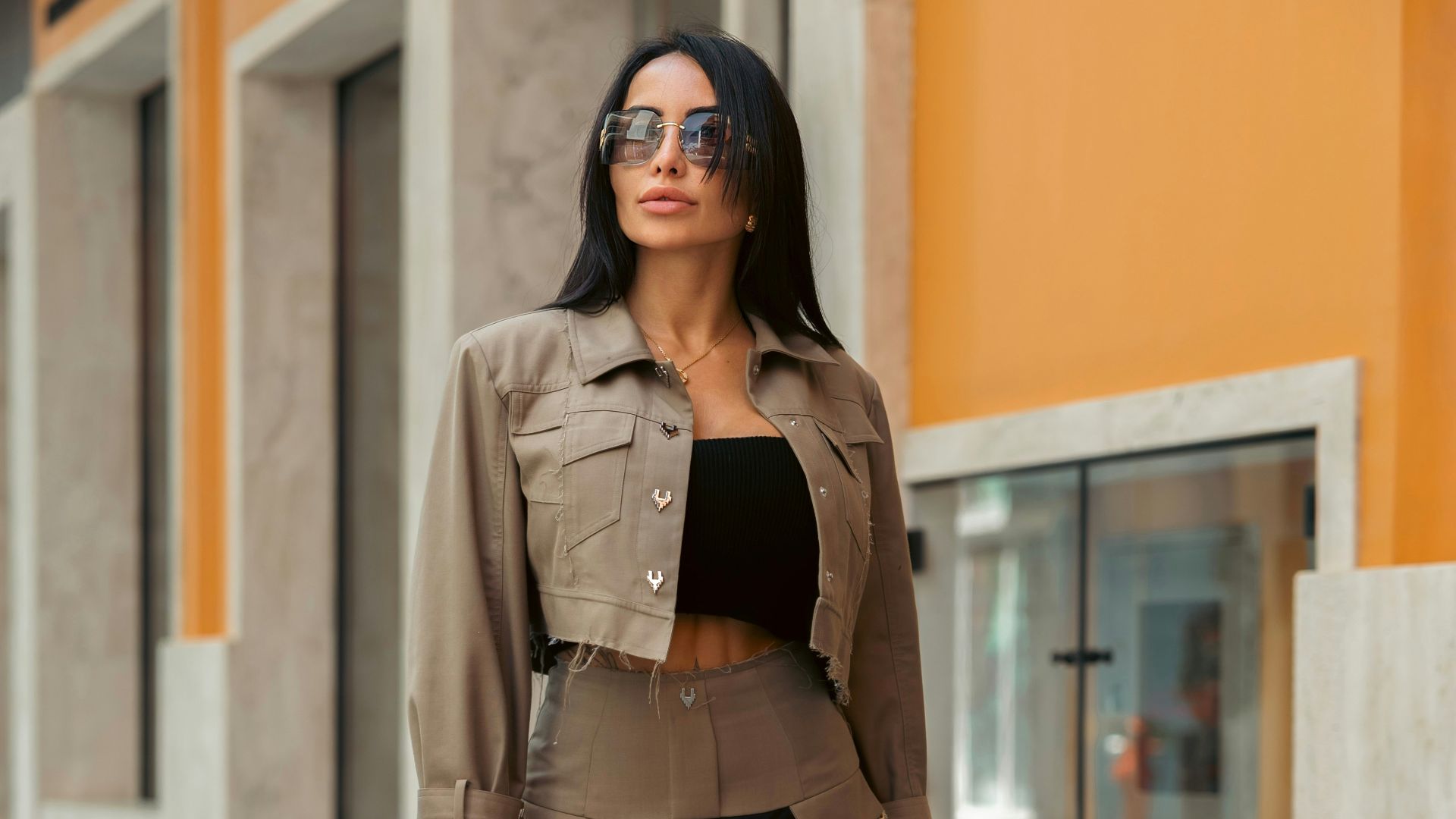 Stylish woman poses with a designer bag.