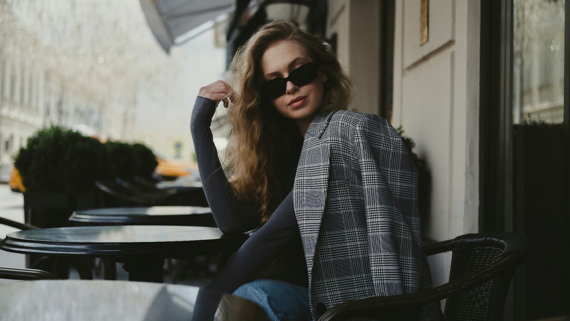 a woman sitting in front of a building