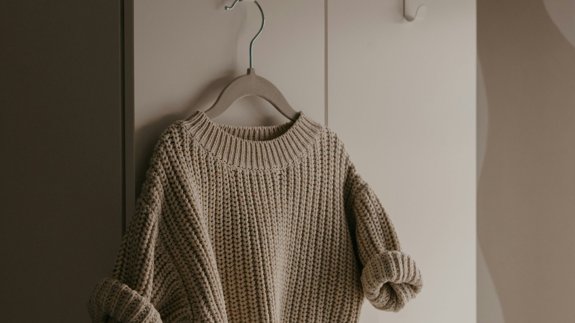 a sweater hanging on a hook in a room