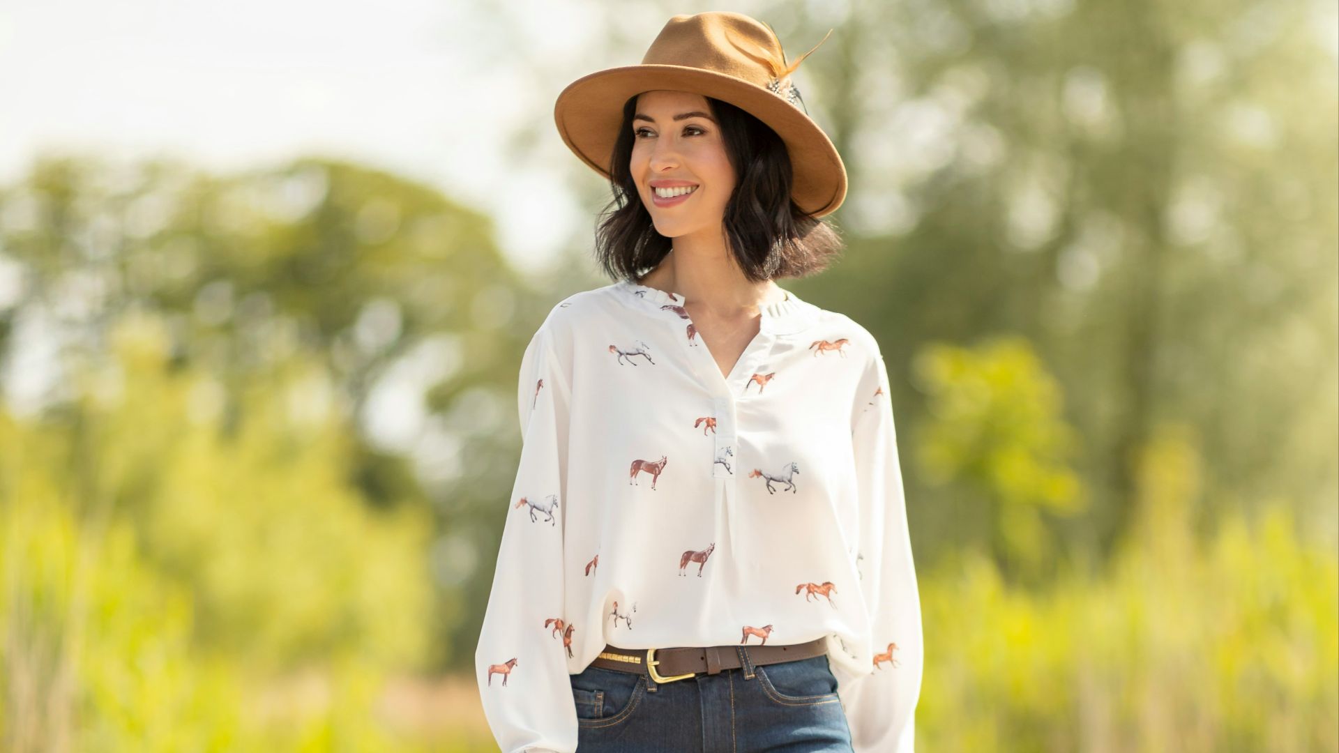A woman in a cowboy hat is walking on a dock