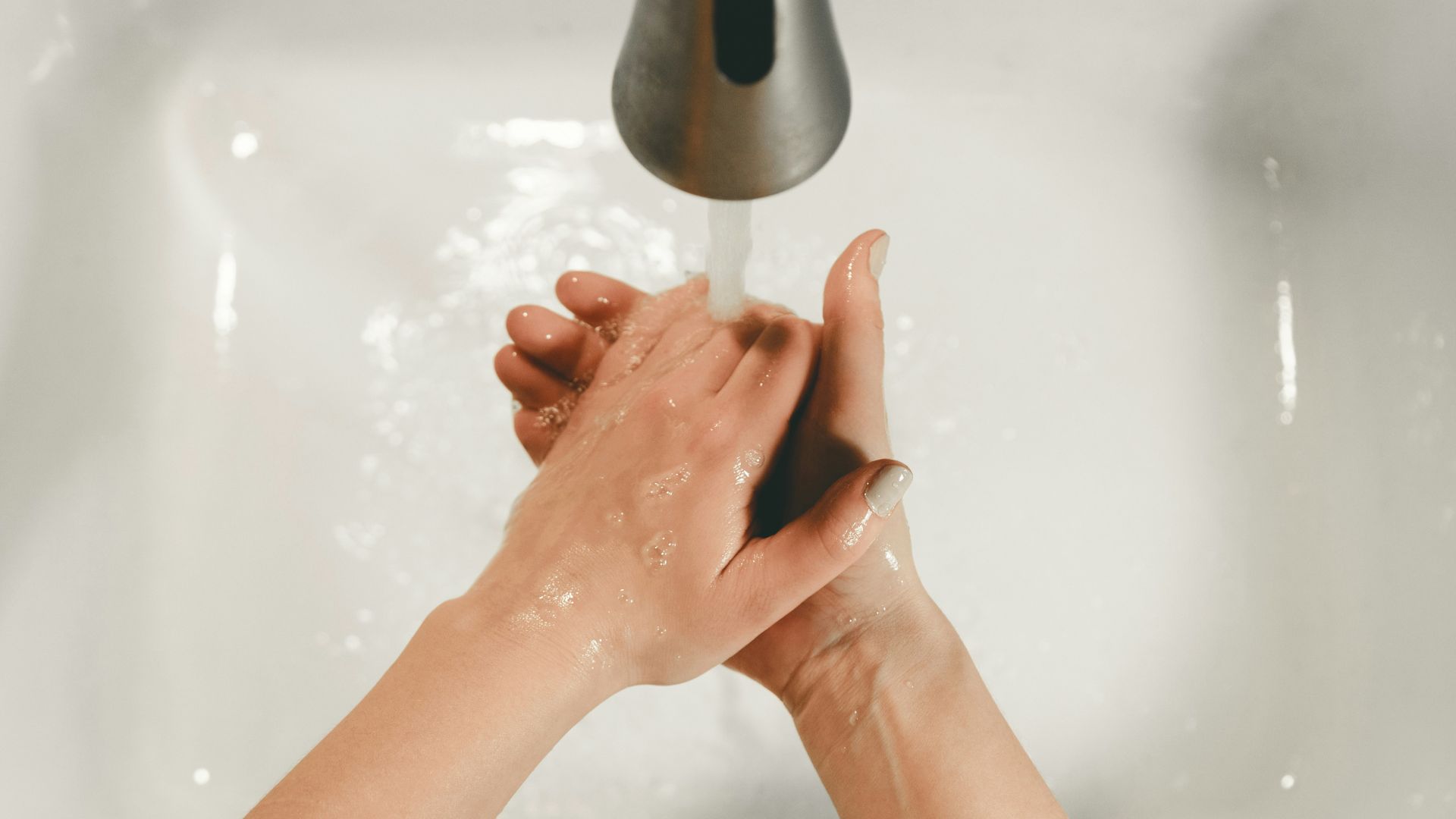 persons feet on white bathtub