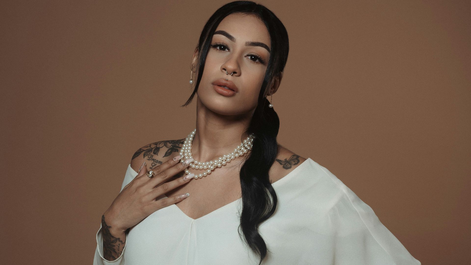 a woman in a white dress posing for a picture