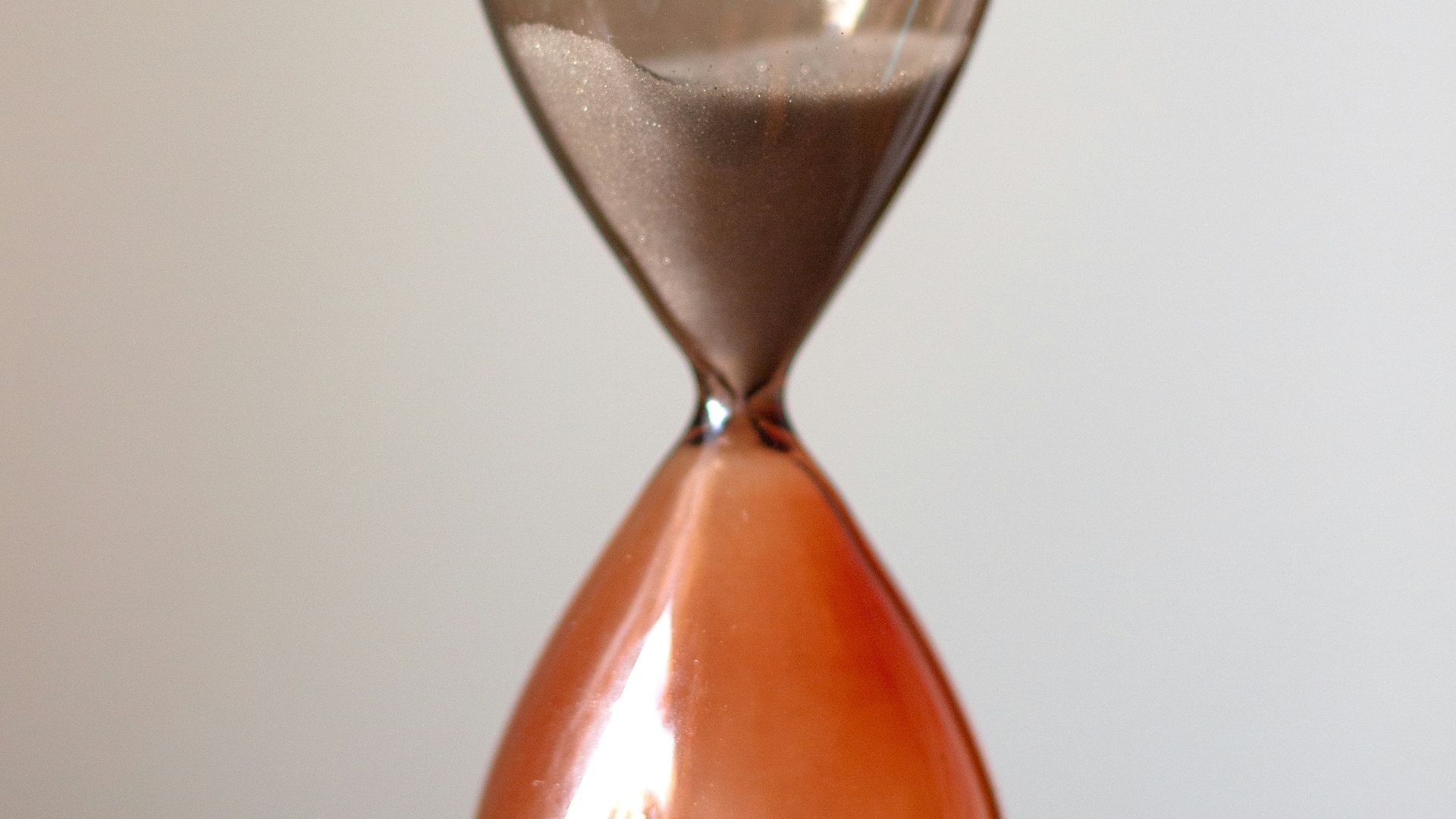 clear hour glass on white table
