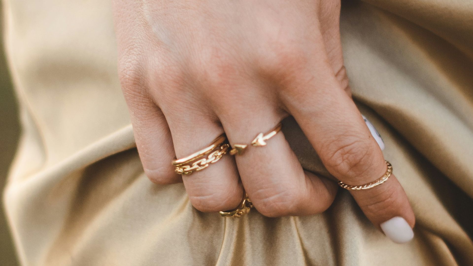 person wearing gold ring and gold ring