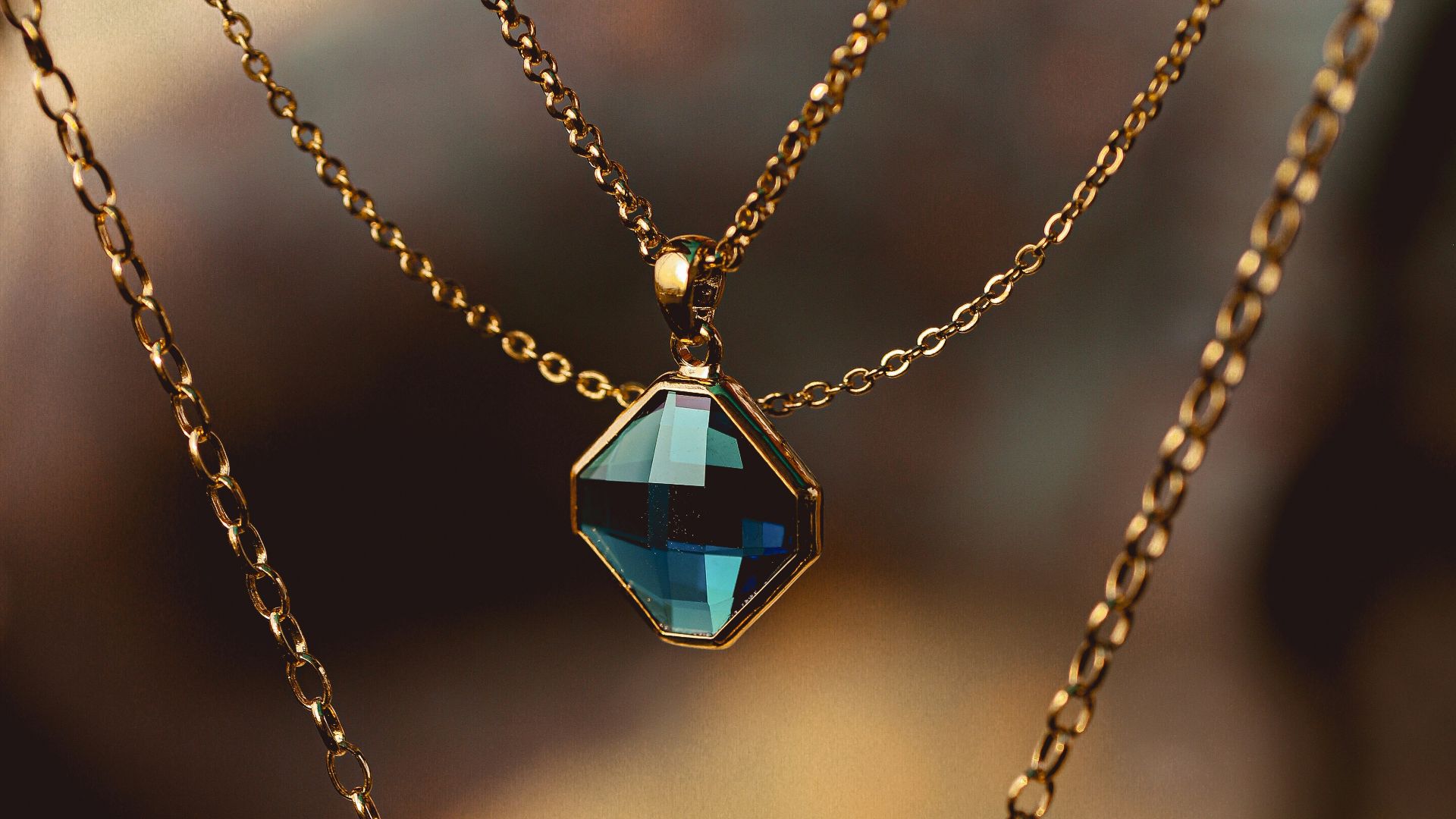 silver chain necklace with blue gemstone pendant