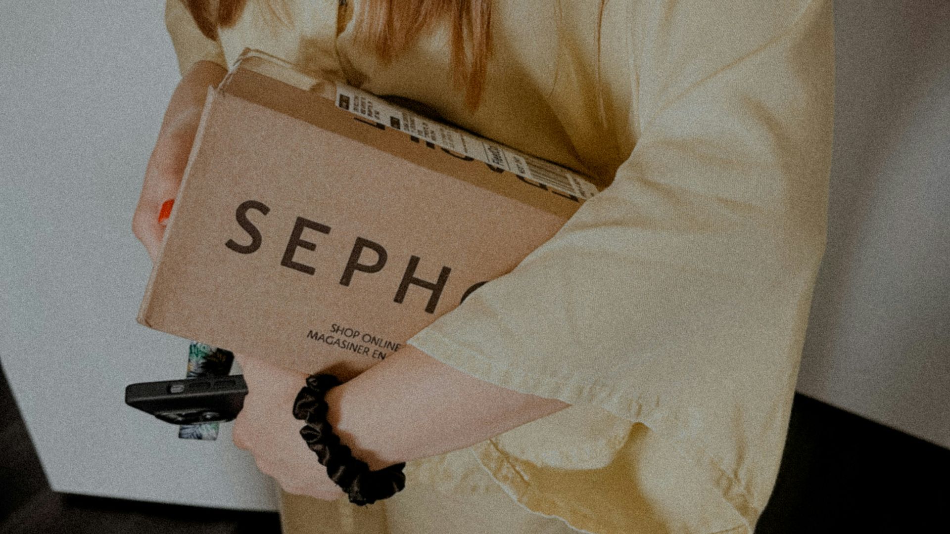 a woman holding a cardboard box with the word sep on it