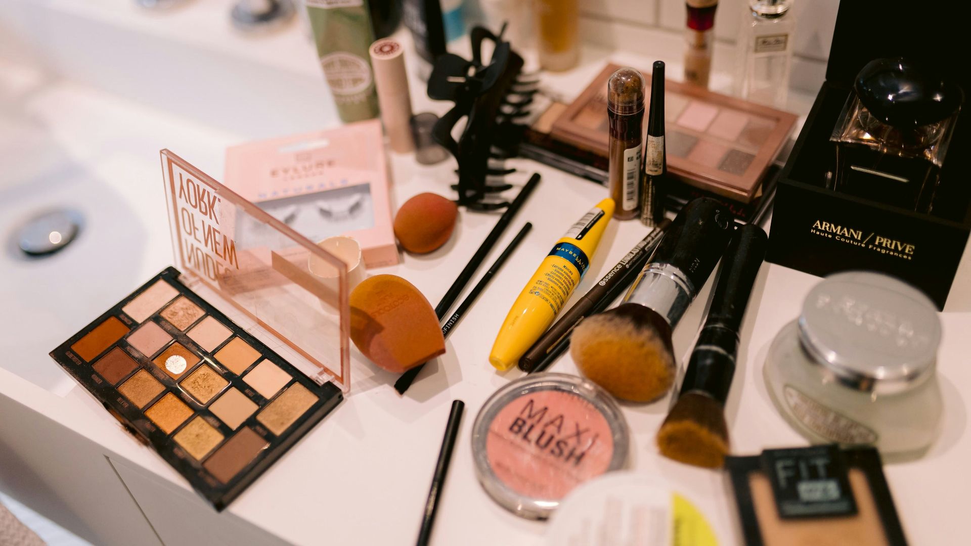 Various makeup products arranged on a surface.