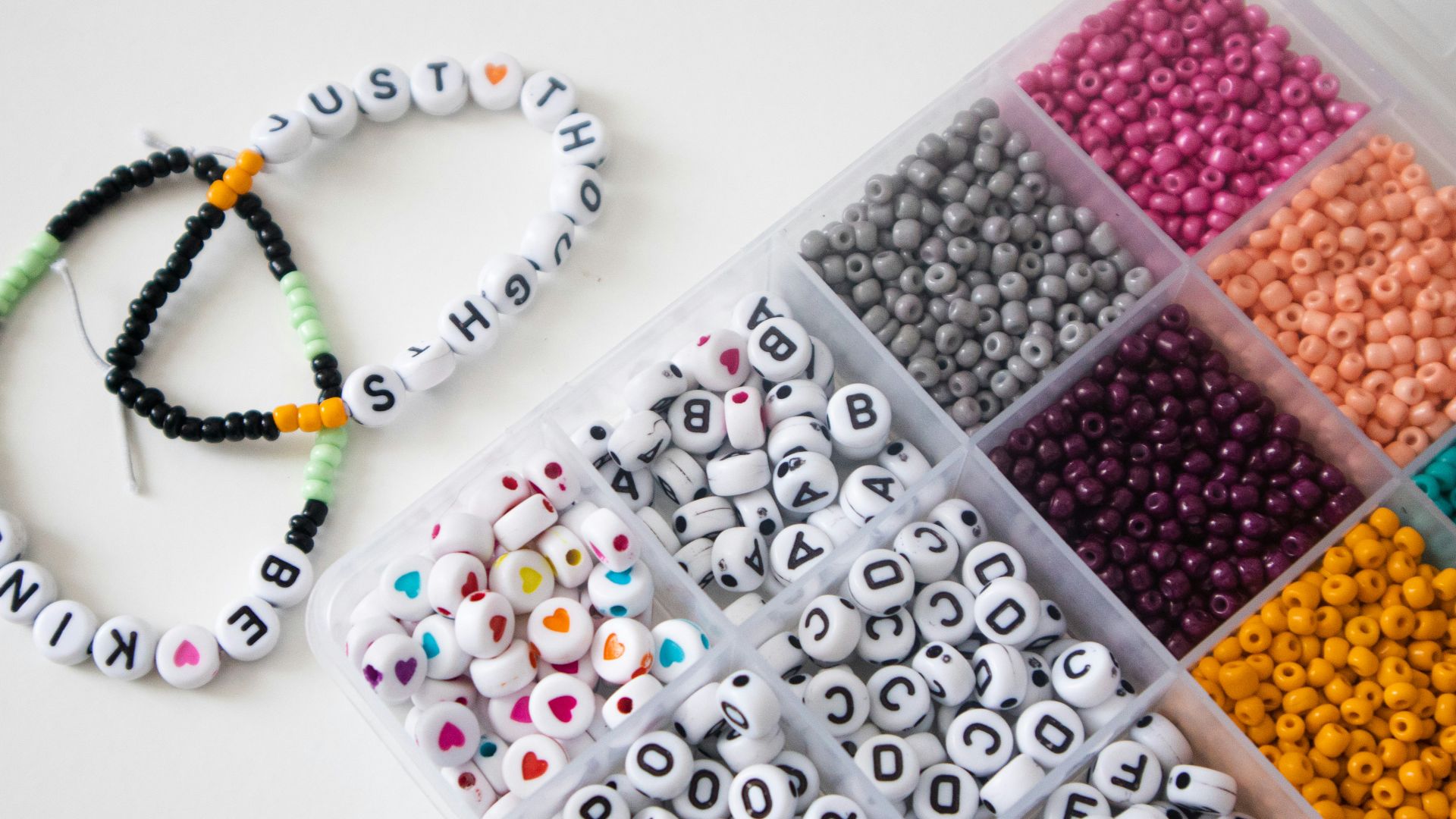 a box filled with lots of different colored beads