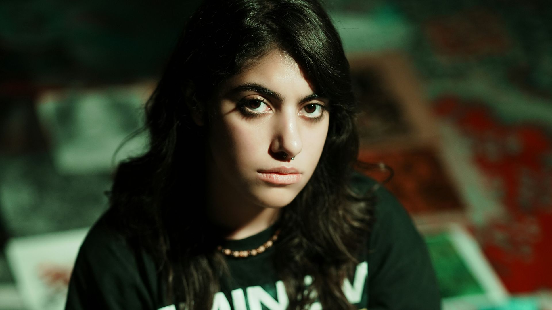 Young woman in eminem t-shirt sits on floor