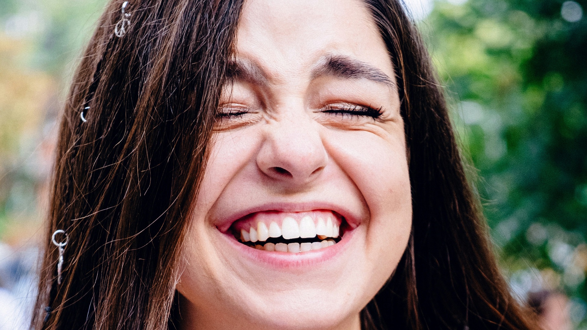 woman in black spaghetti strap top smiling