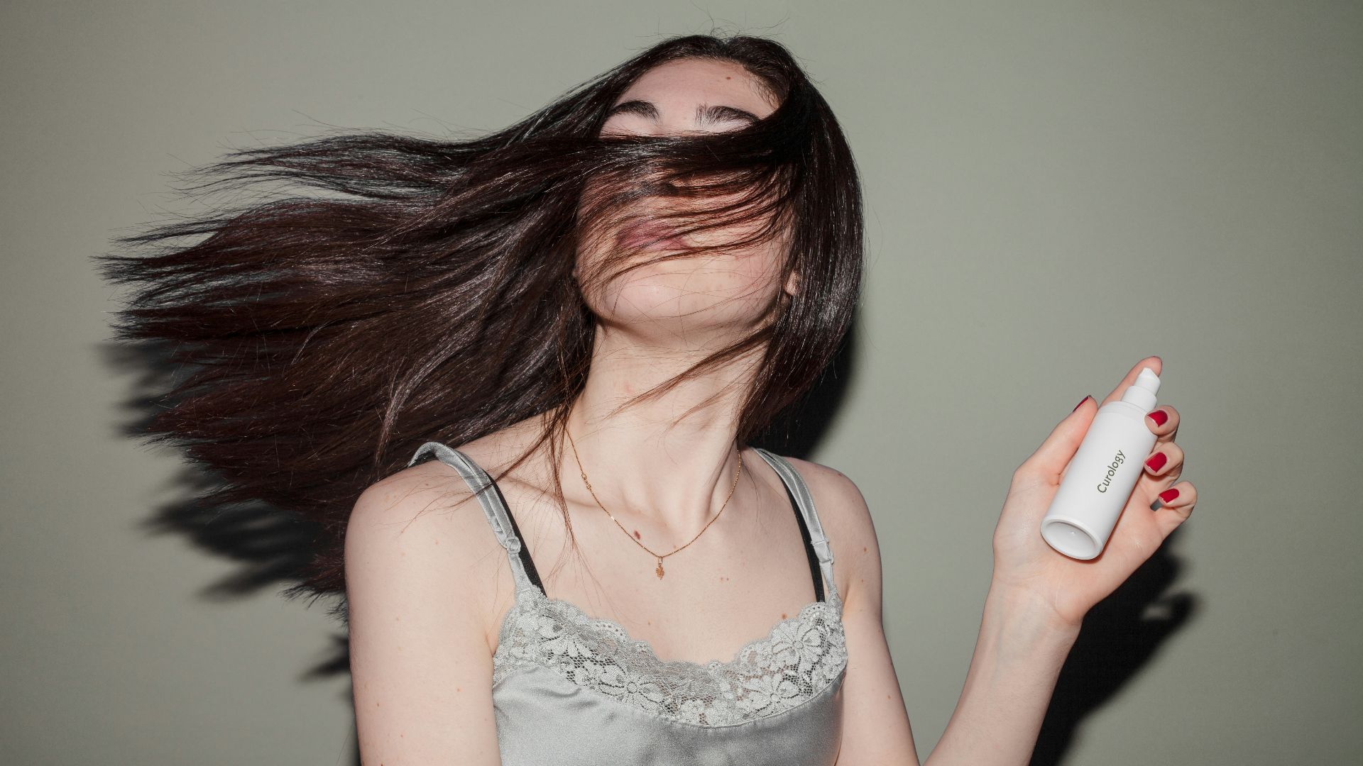 woman holding spray bottle