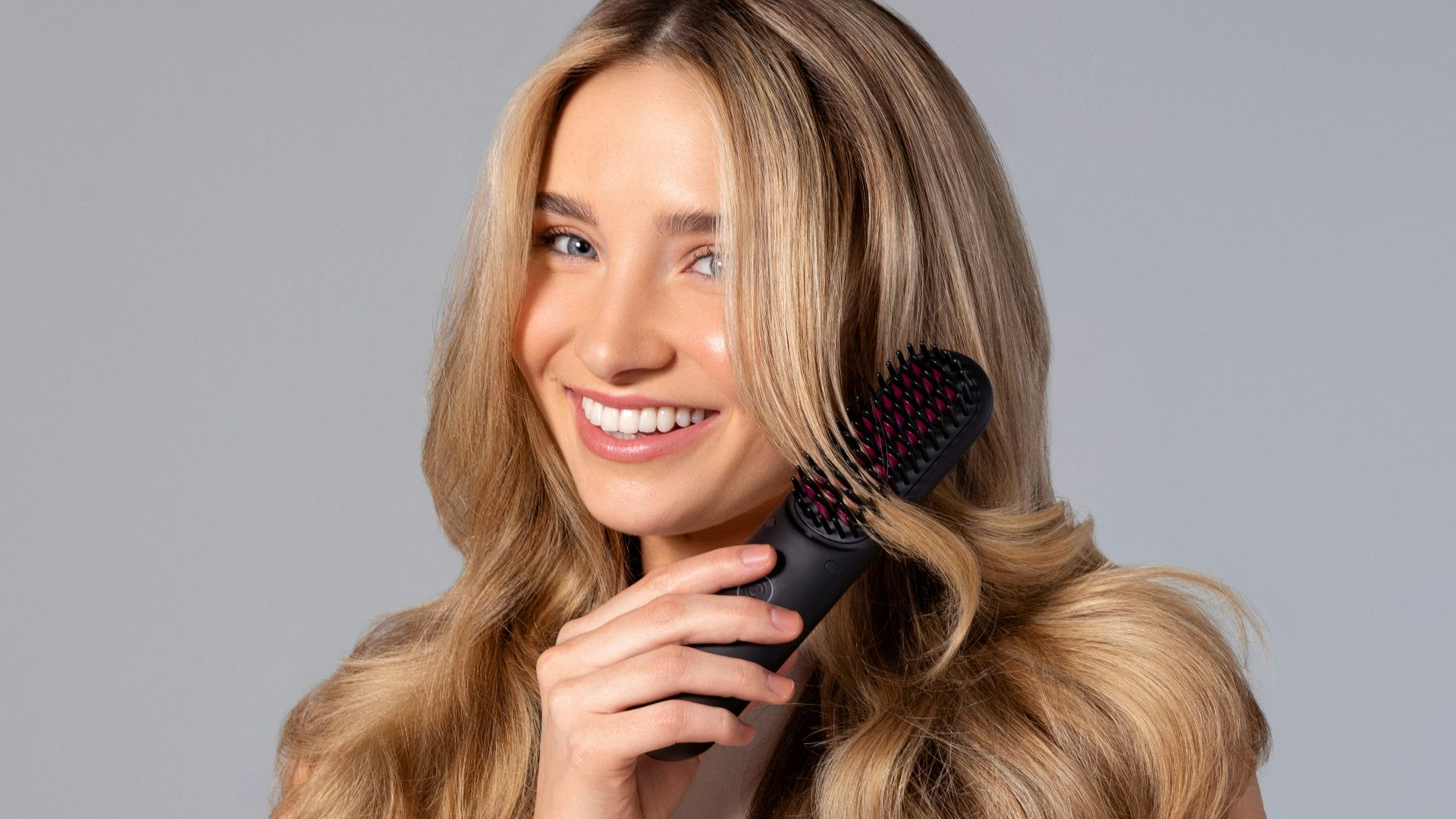 a woman holding a hair brush in her hand