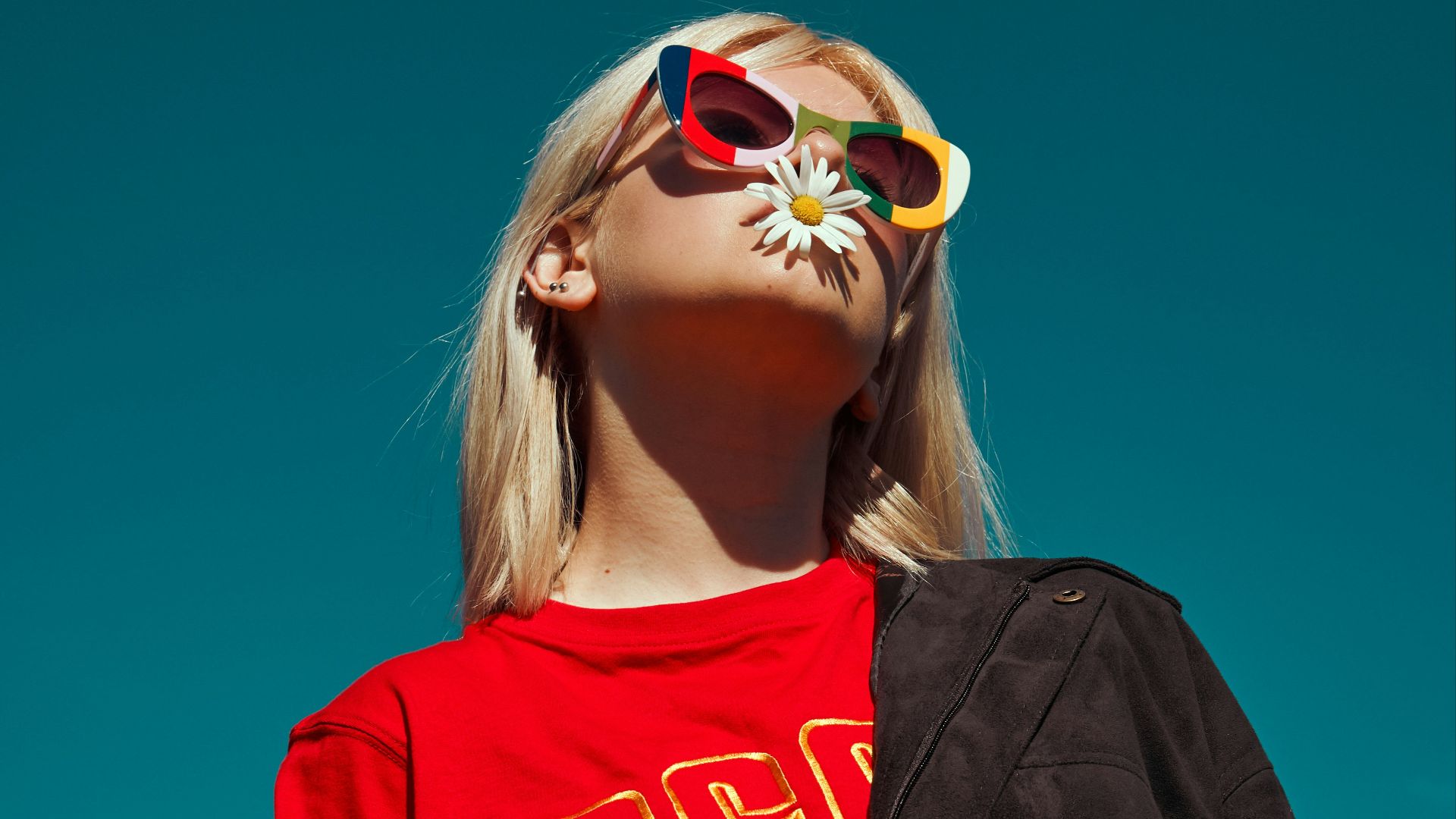 woman with sunglasses standing outdoor during daytime