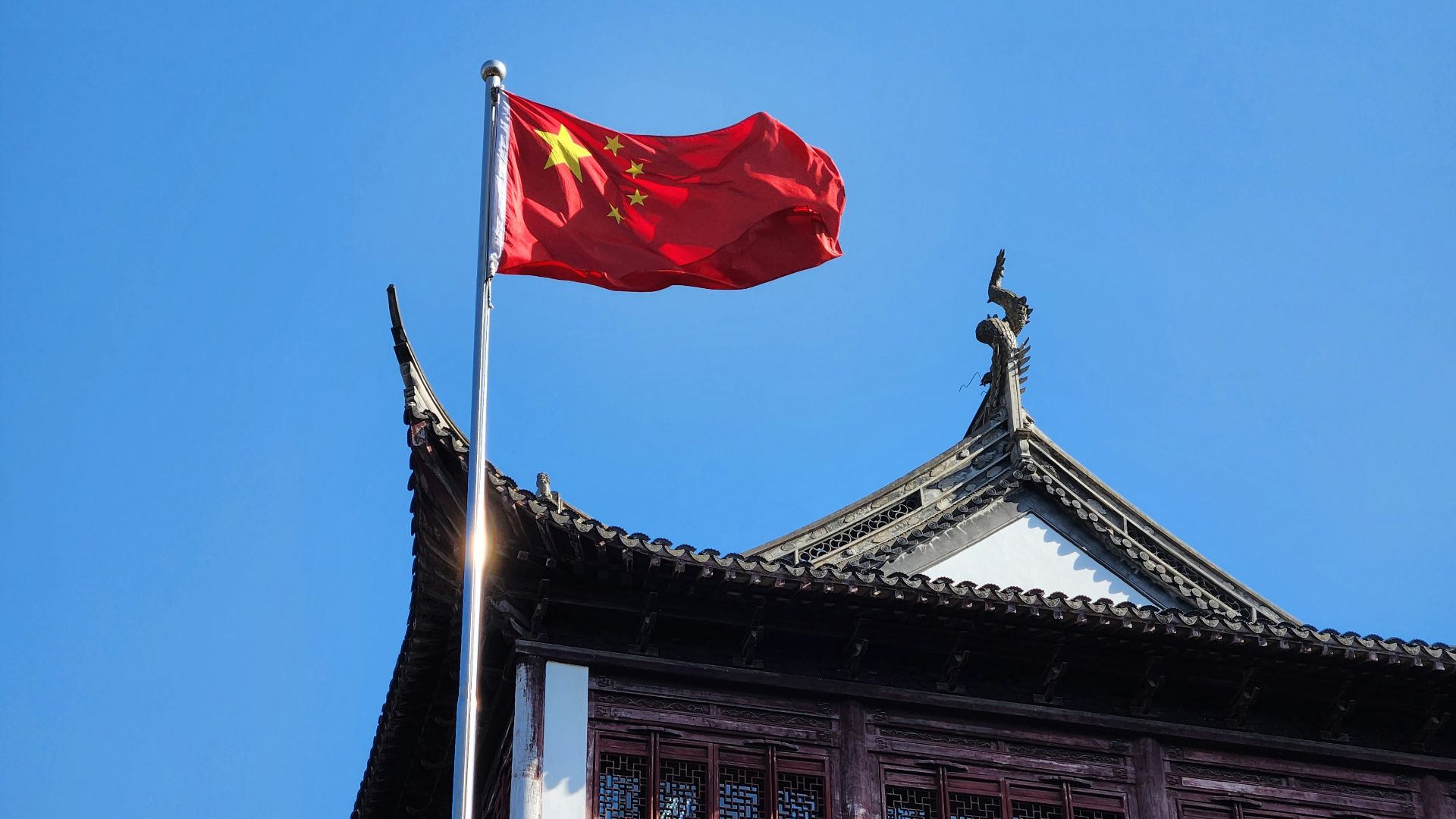 A chinese flag flying on top of a building