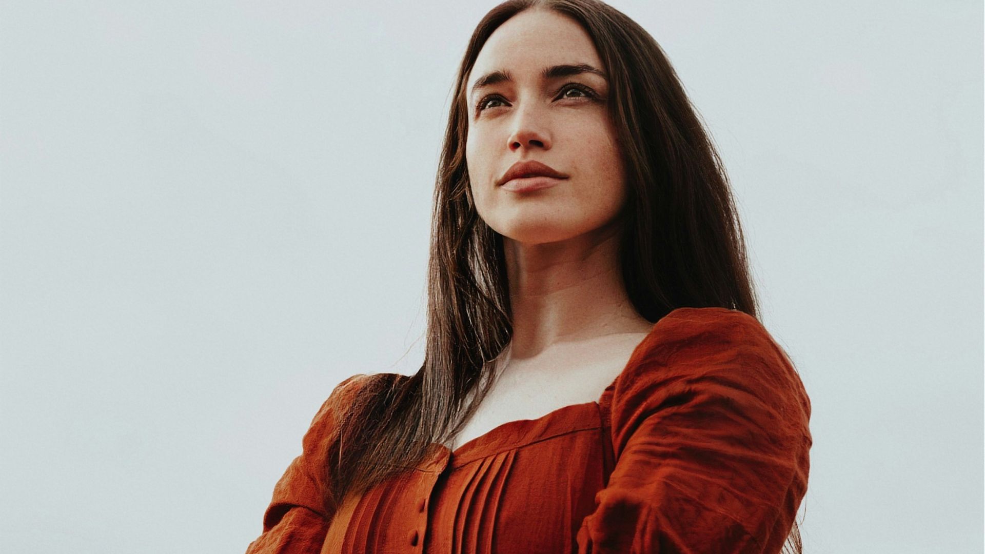 a woman in a red dress is posing for a picture