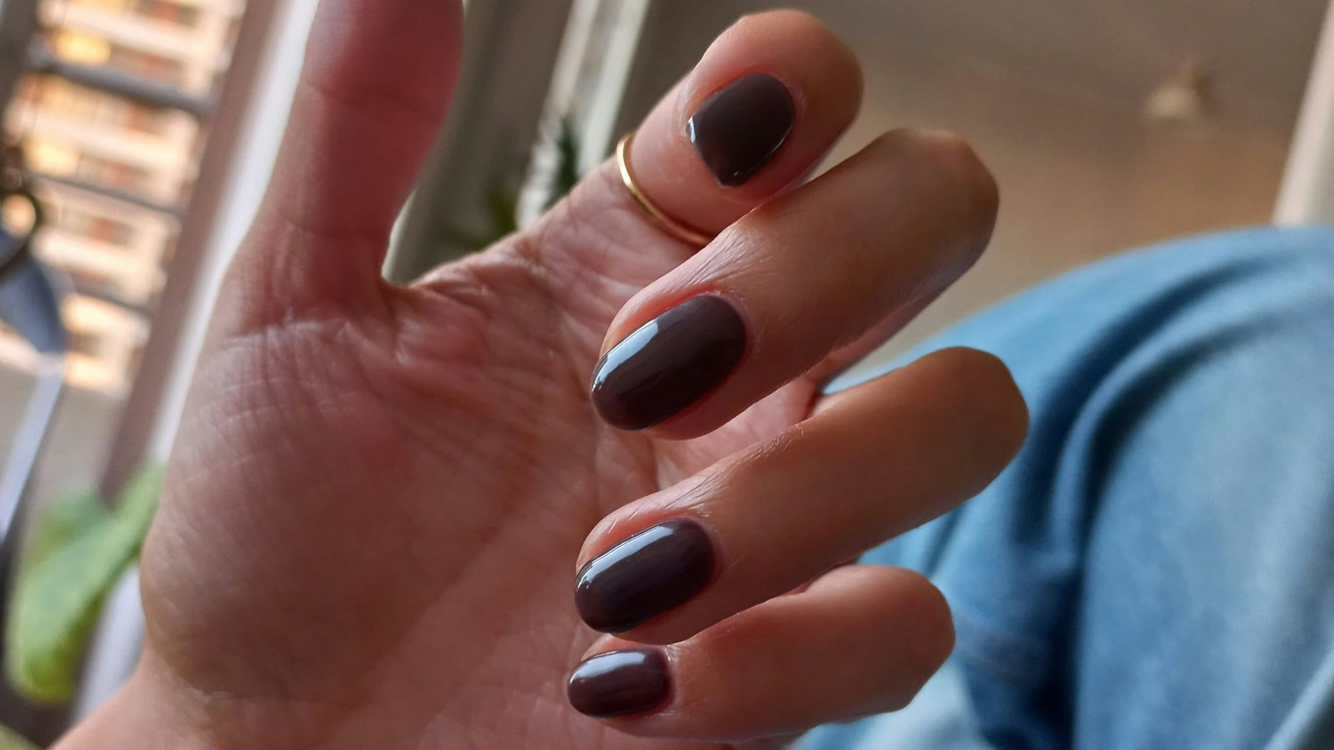 Hand with painted nails and a ring.