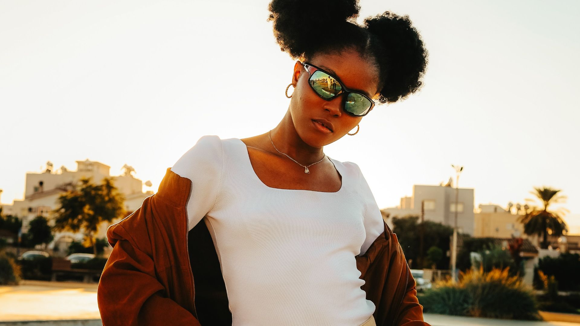 Young woman with buns posing at a skate park