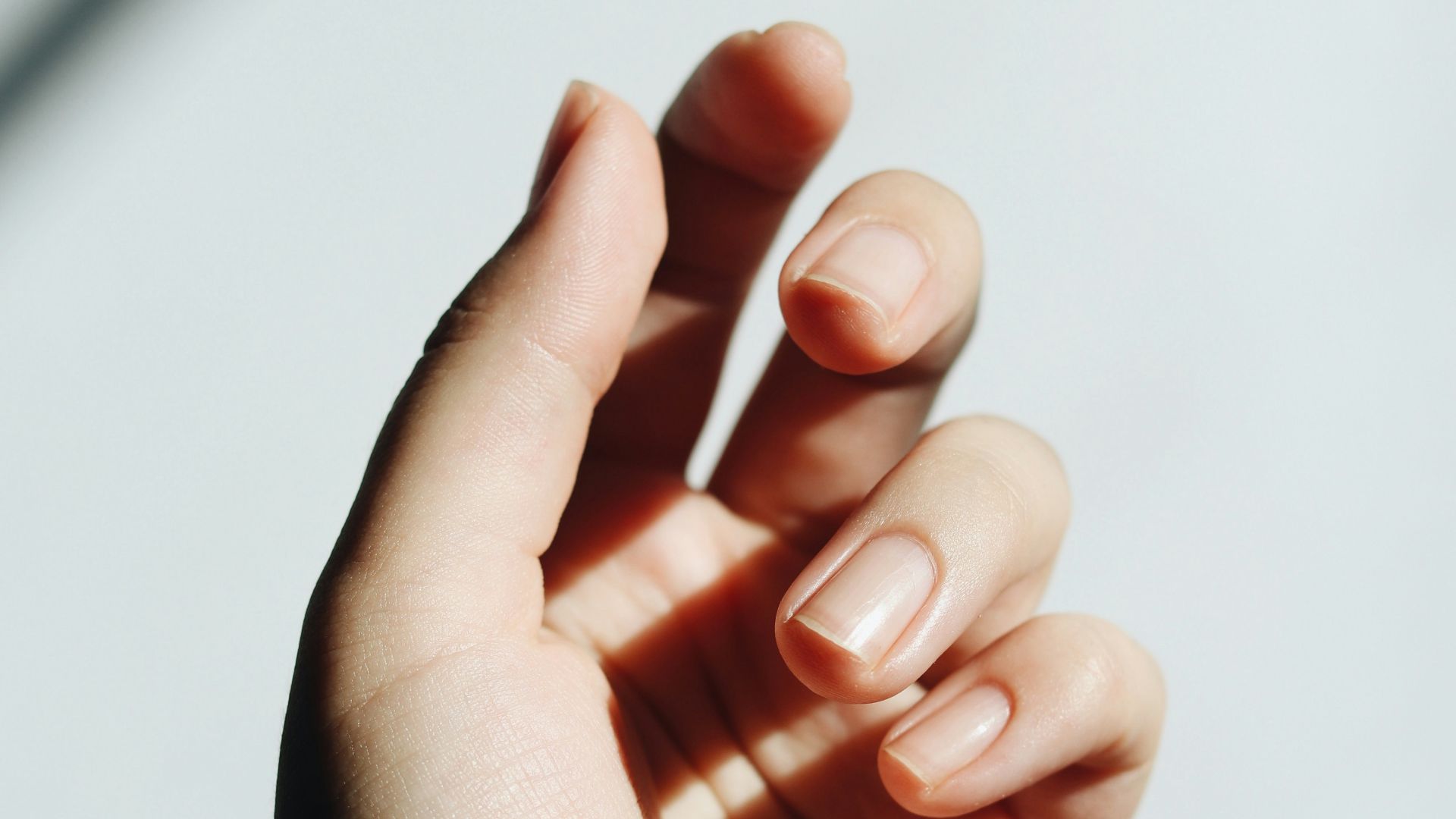 persons left hand on white table