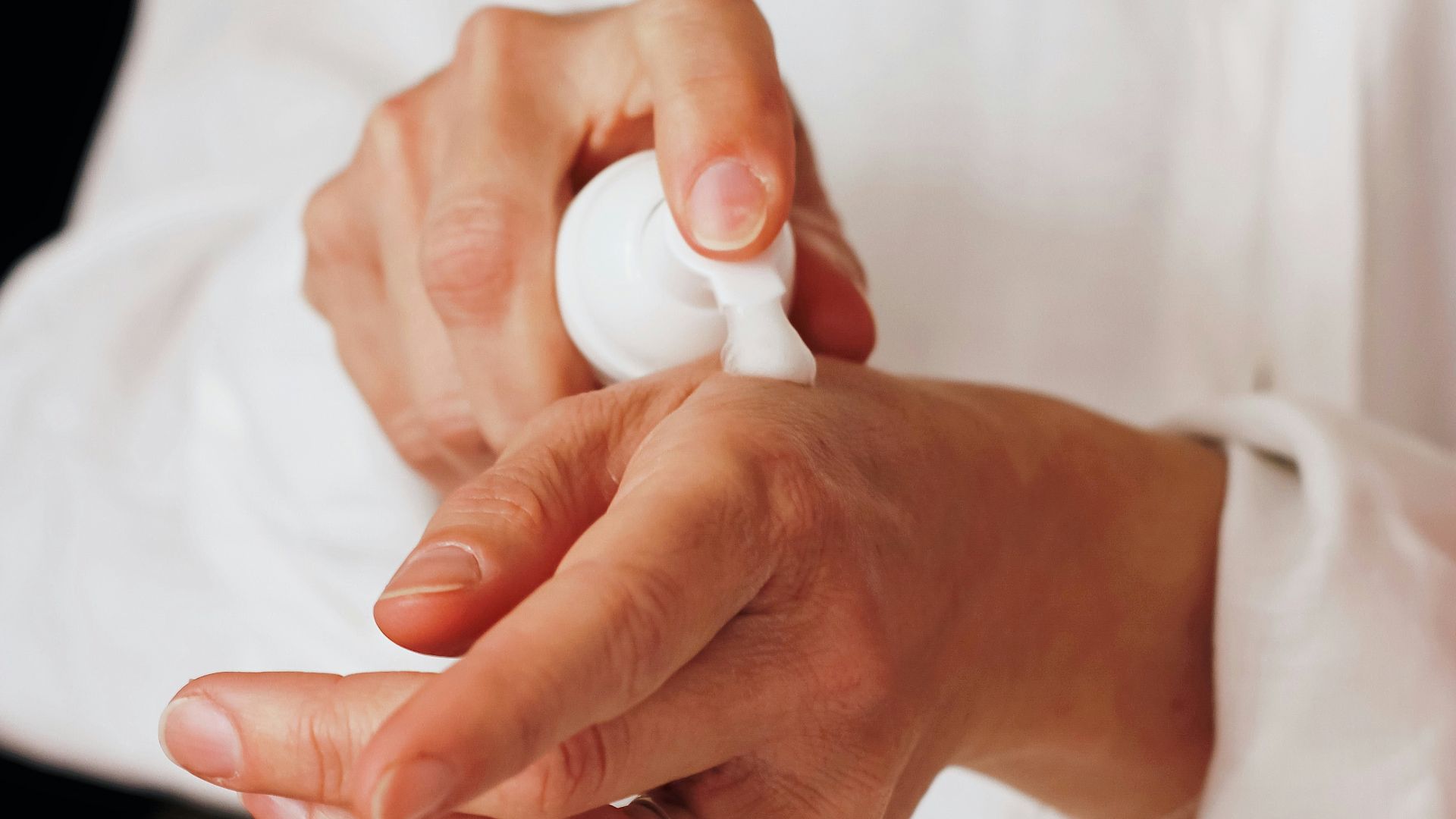 person holding white round ornament