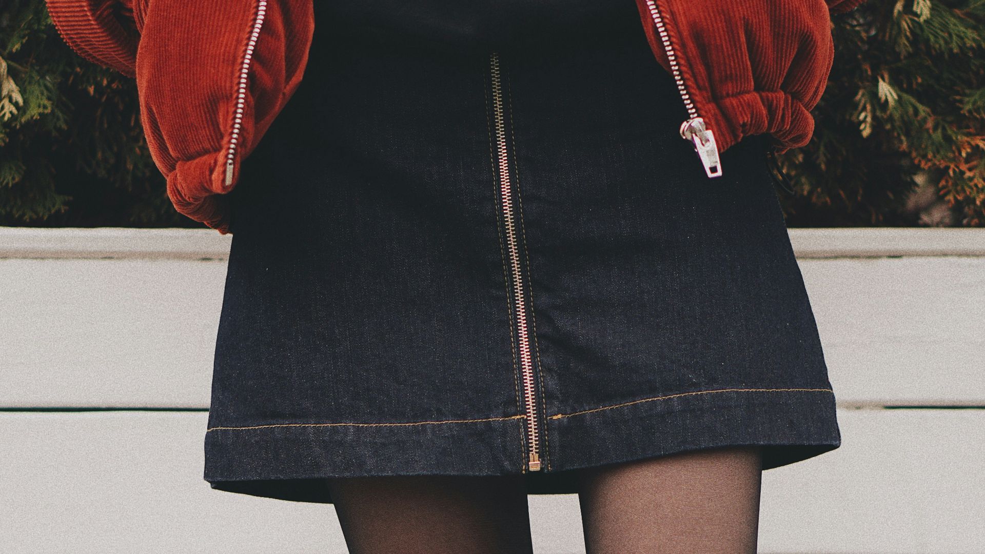 woman wearing black denim skirt and thigh high socks