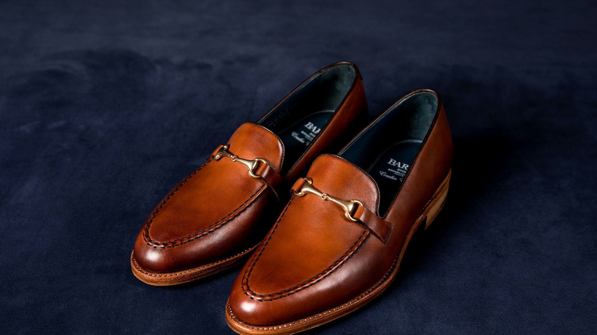 brown leather loafers on blue textile