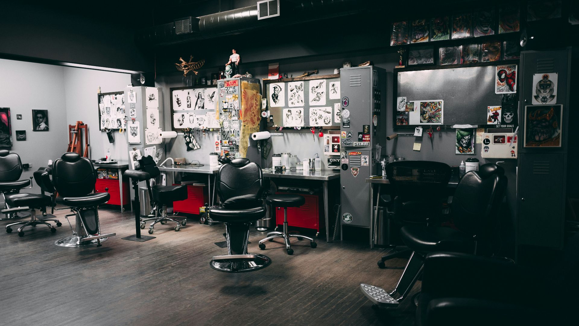 a barber shop with chairs and pictures on the wall