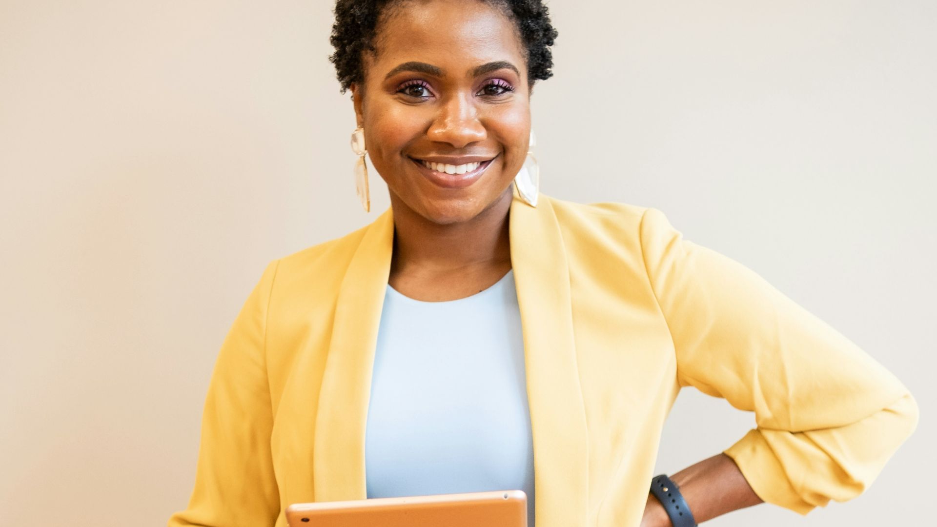 man in yellow blazer and blue denim jeans smiling