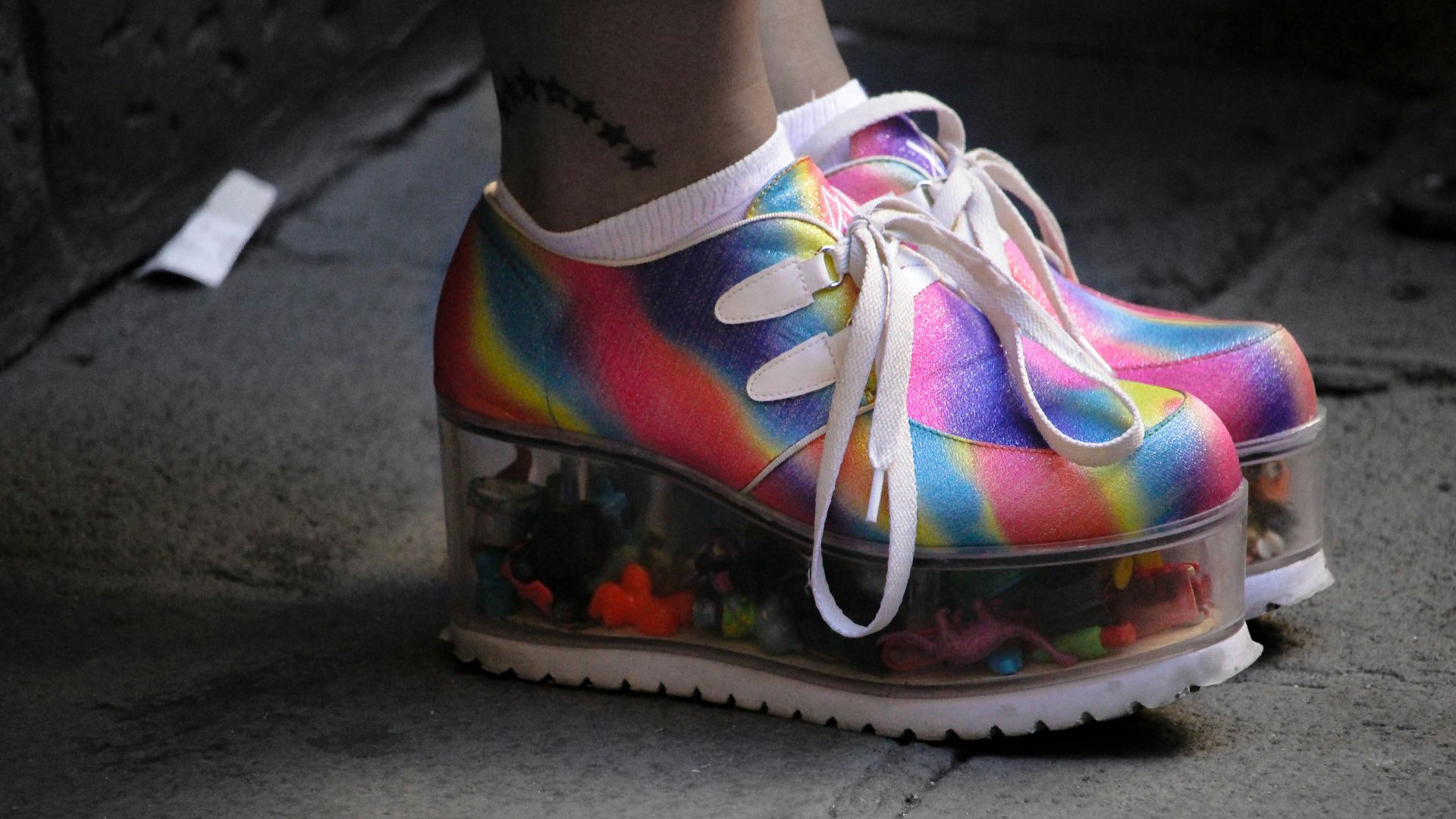 person wearing multicolored wedge shoes