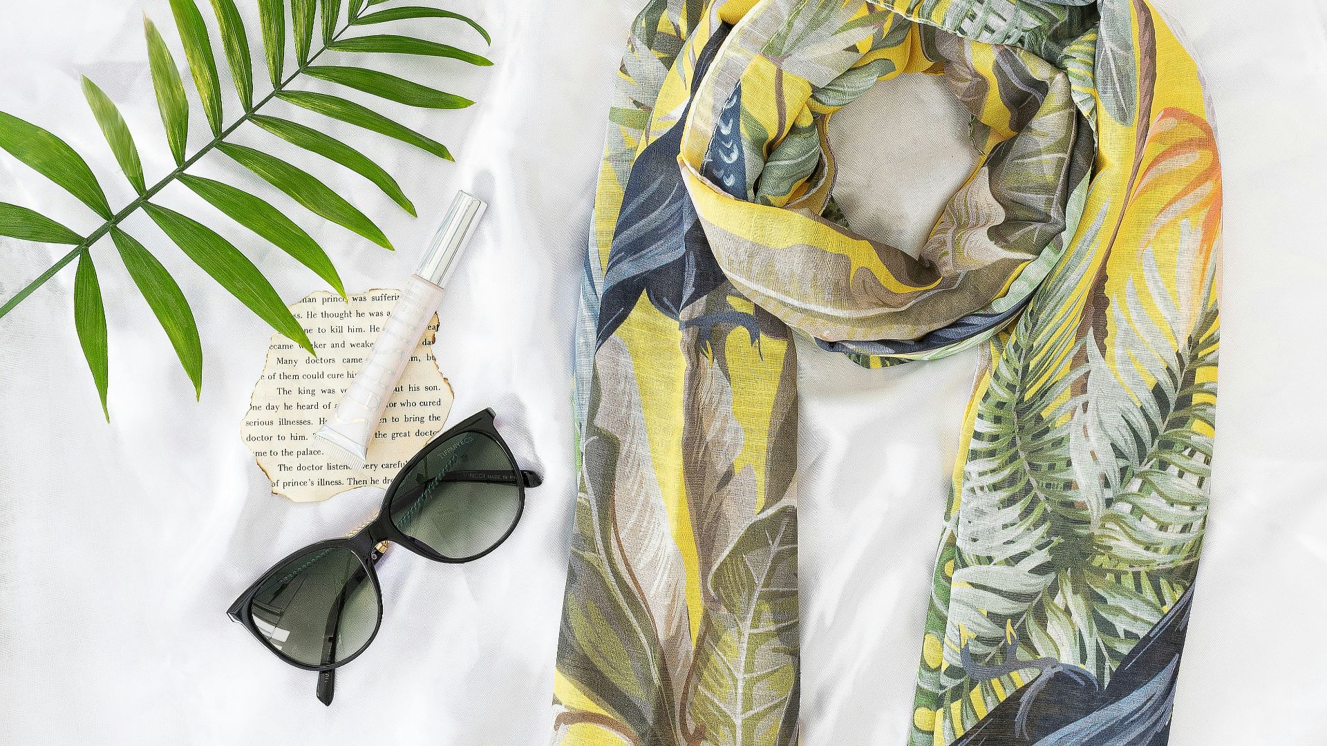 black sunglasses on yellow and white textile