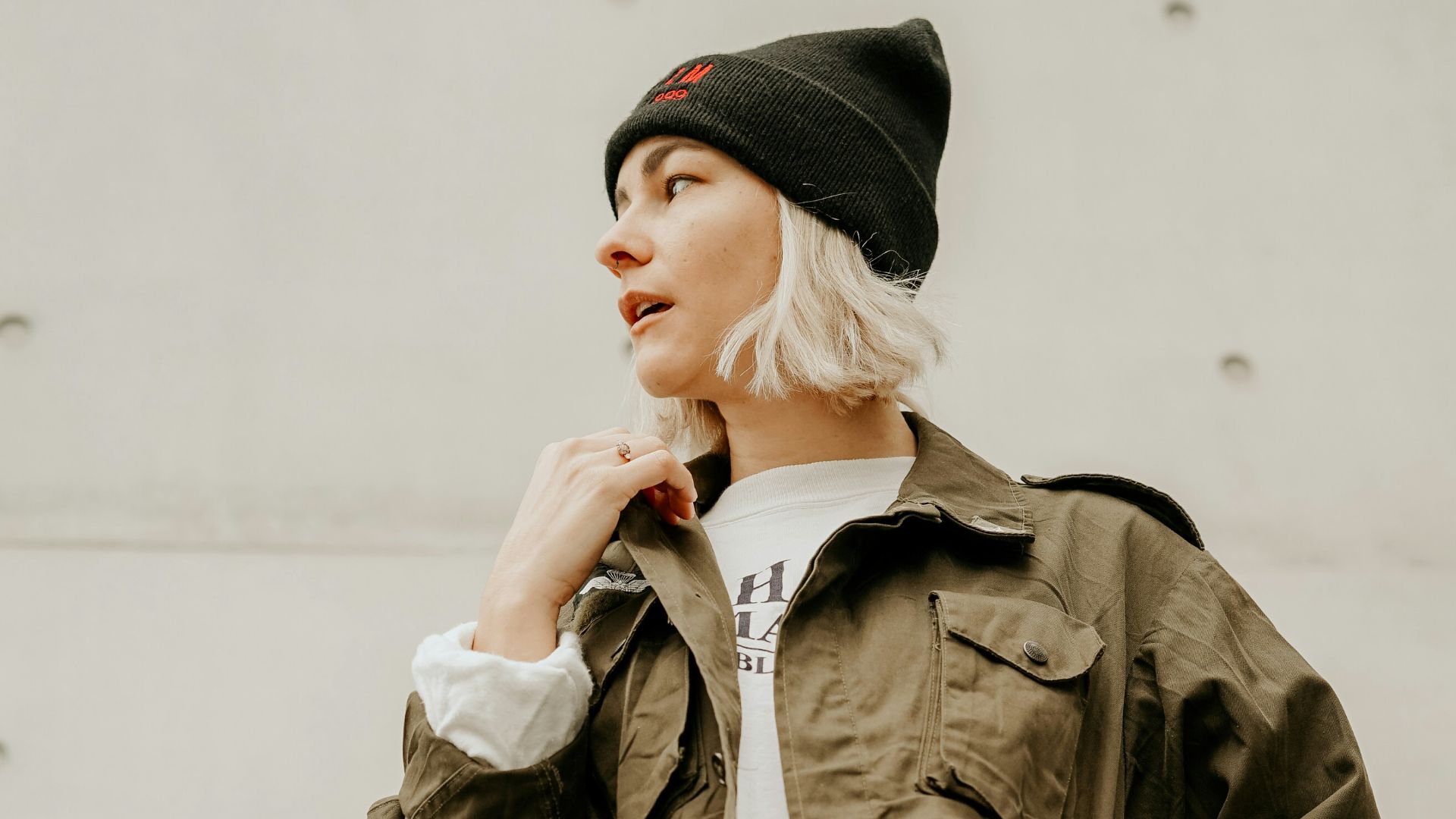 woman in brown jacket with white inner shirt and blue denim jeans