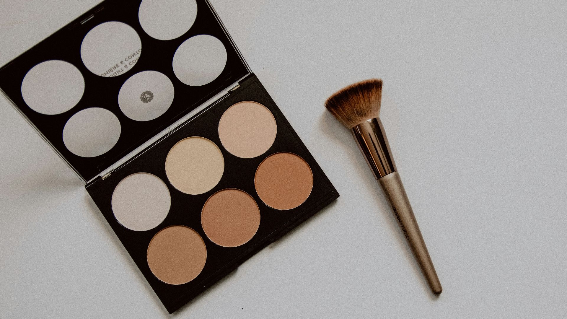 brown and white makeup brush