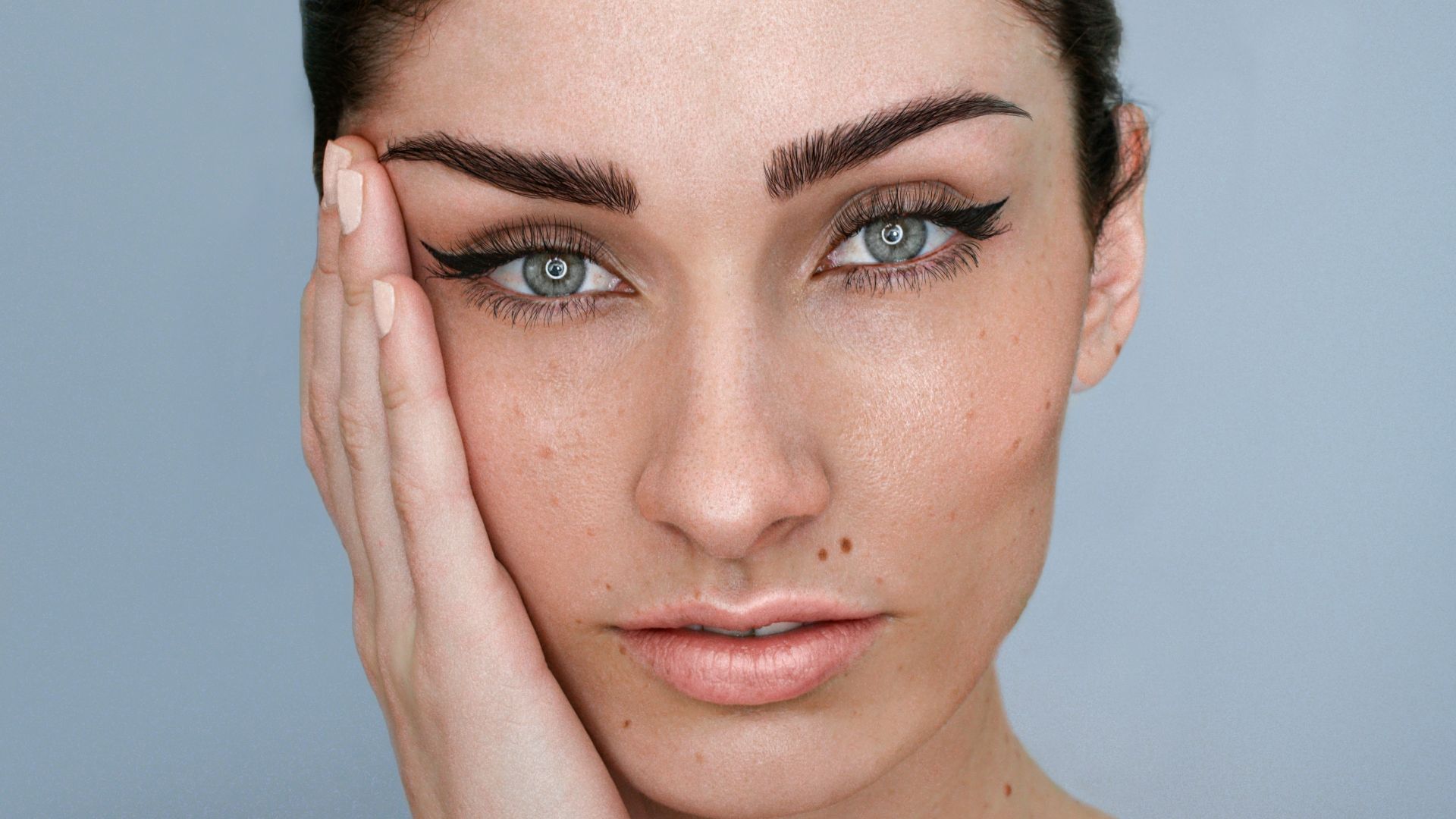a woman with her hand on her face