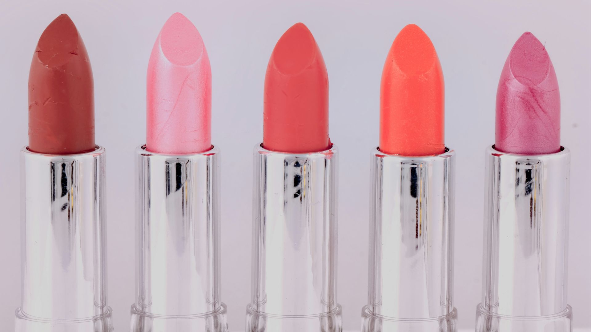 five assorted-color lipsticks