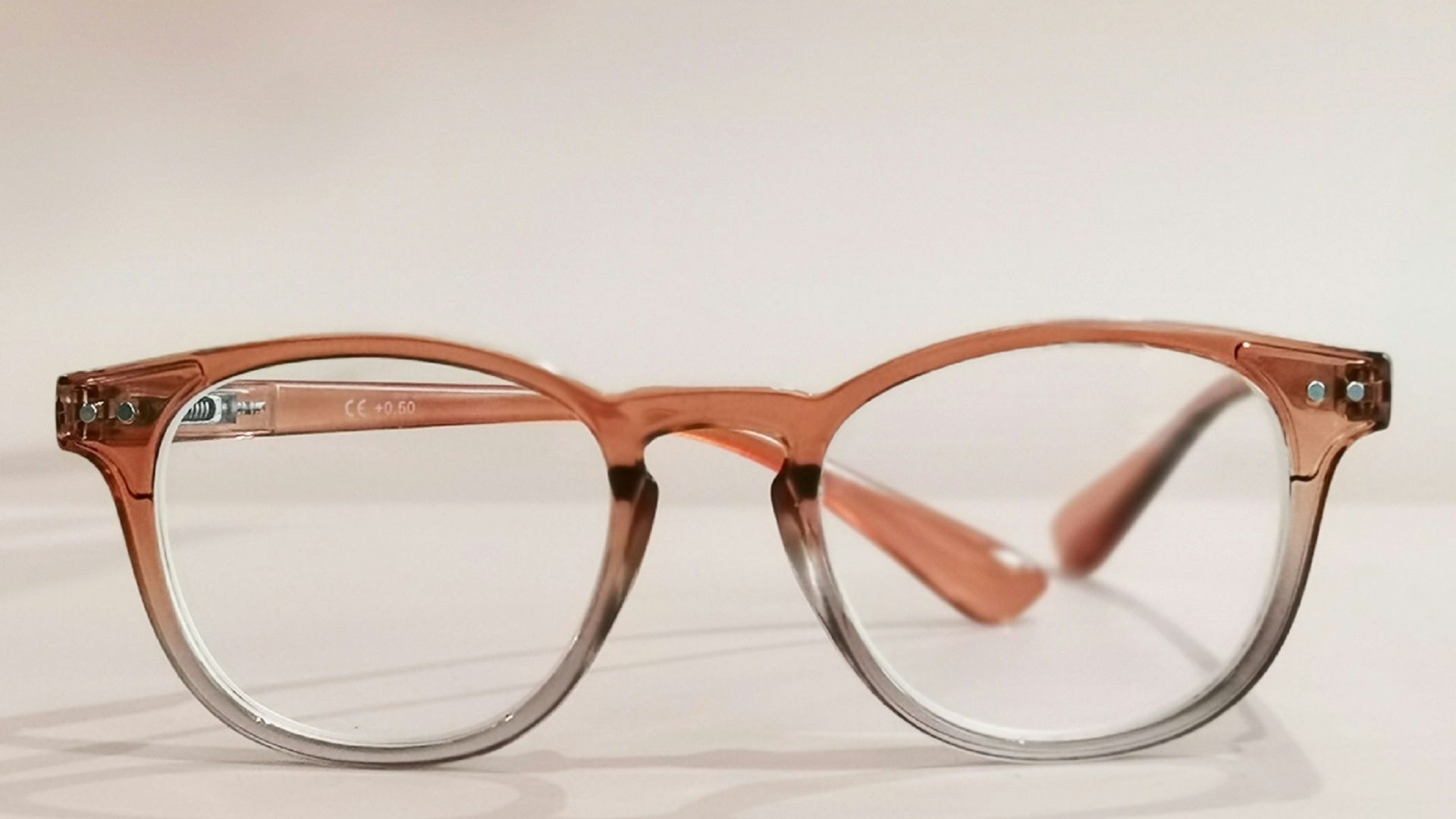 a pair of glasses sitting on top of a table