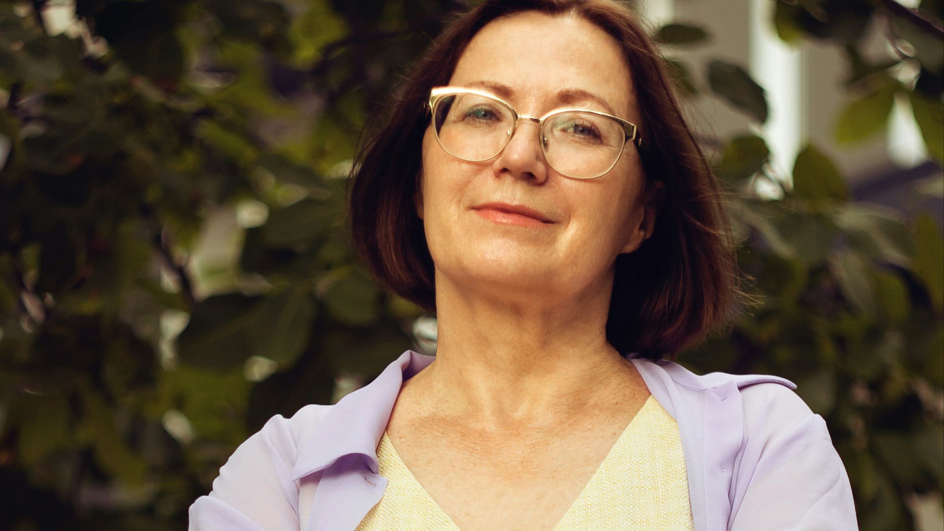 woman in white long sleeve shirt smiling