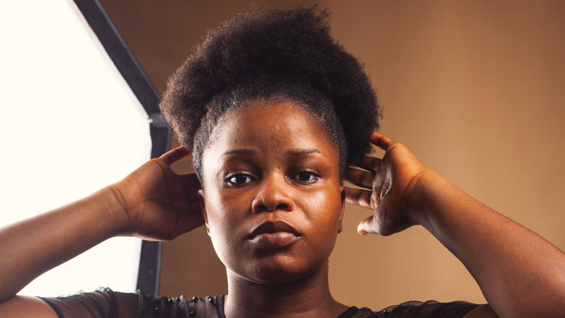 man in black tank top holding clear drinking glass