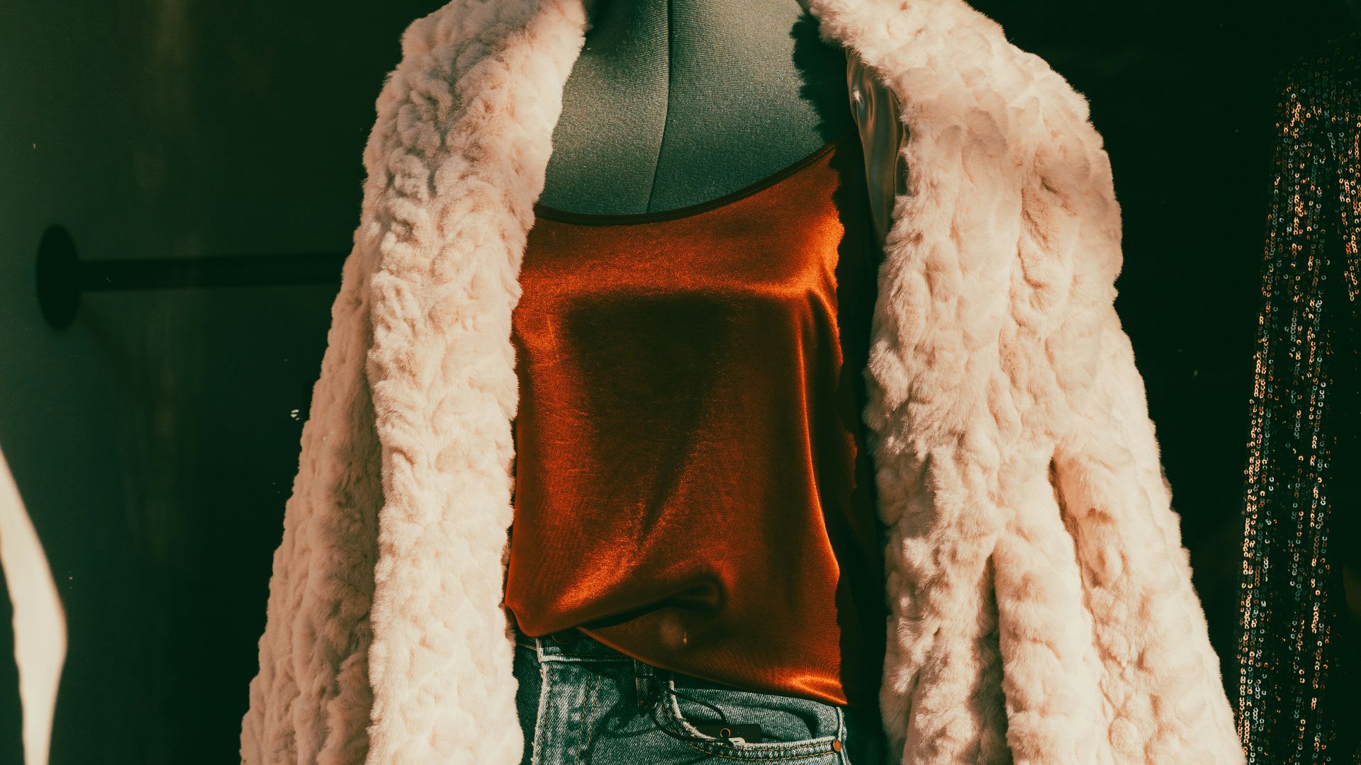 a woman's white fur coat on a mannequin