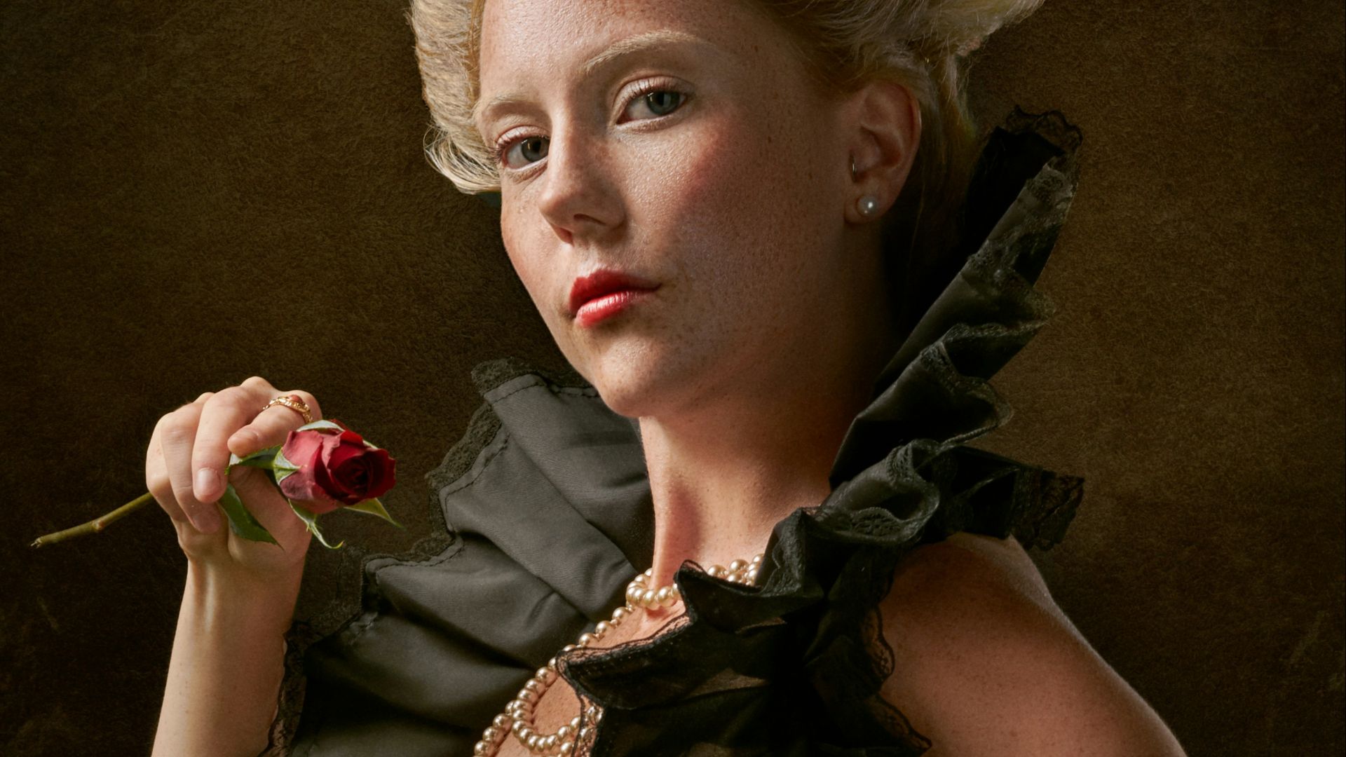 woman wearing red, blue, and white floral jaboot-neckline dress