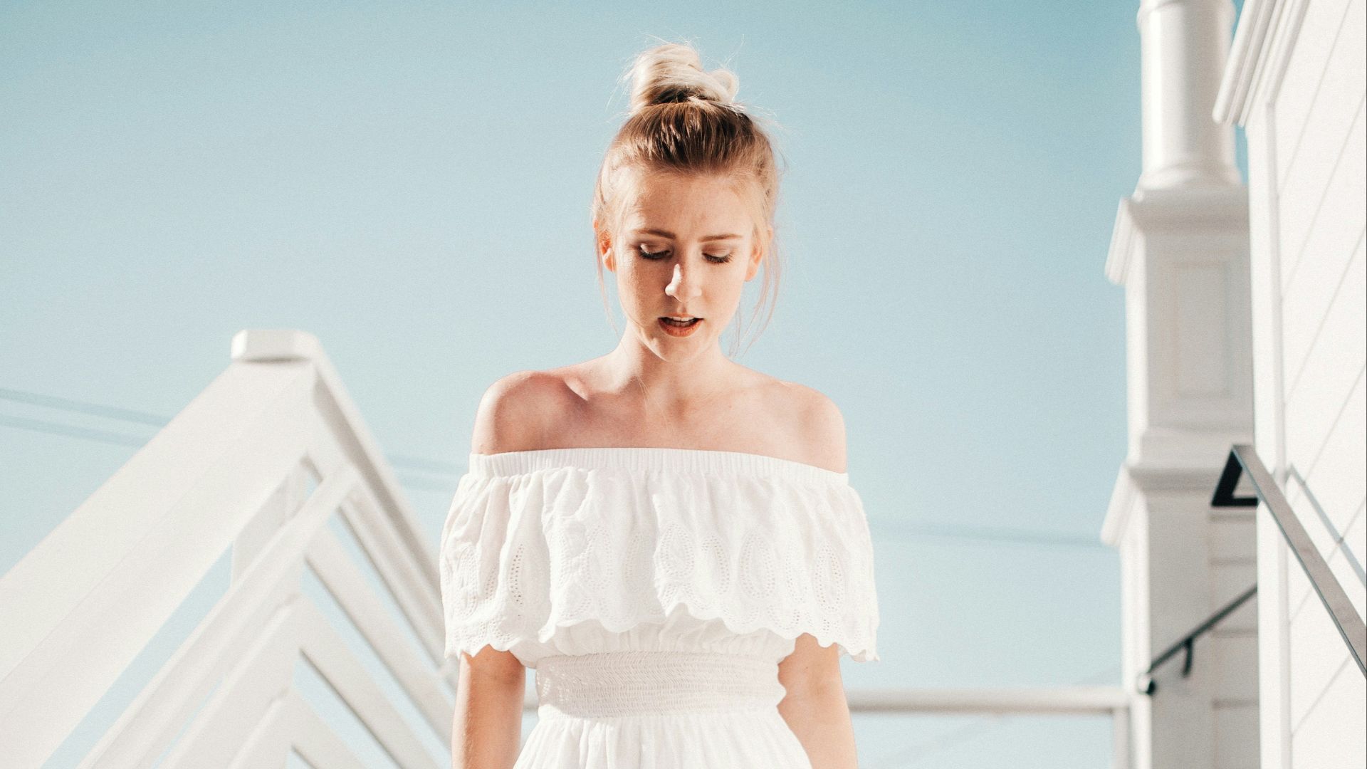 woman walking down stair under clear blue sky during daytime