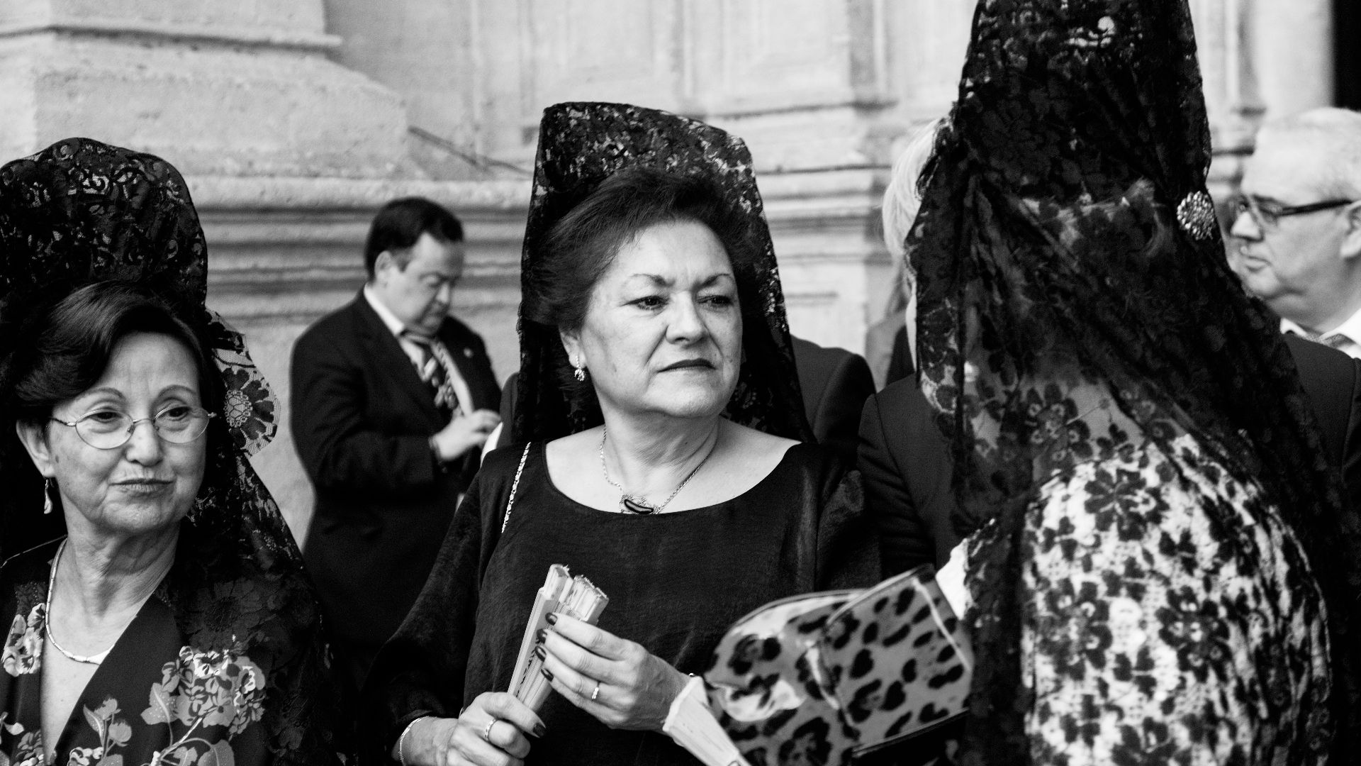 woman in black long sleeve shirt holding white and black leopard print textile