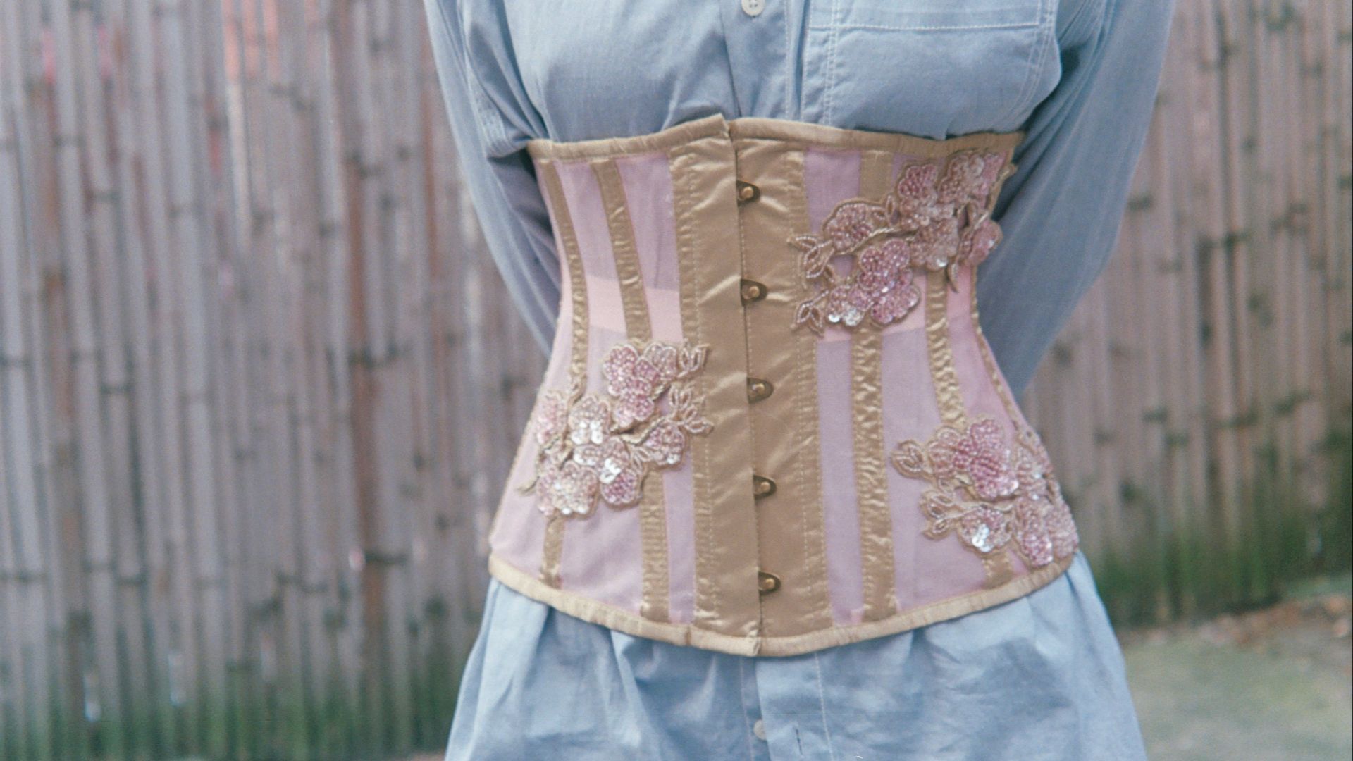 a woman wearing a corset made of fabric